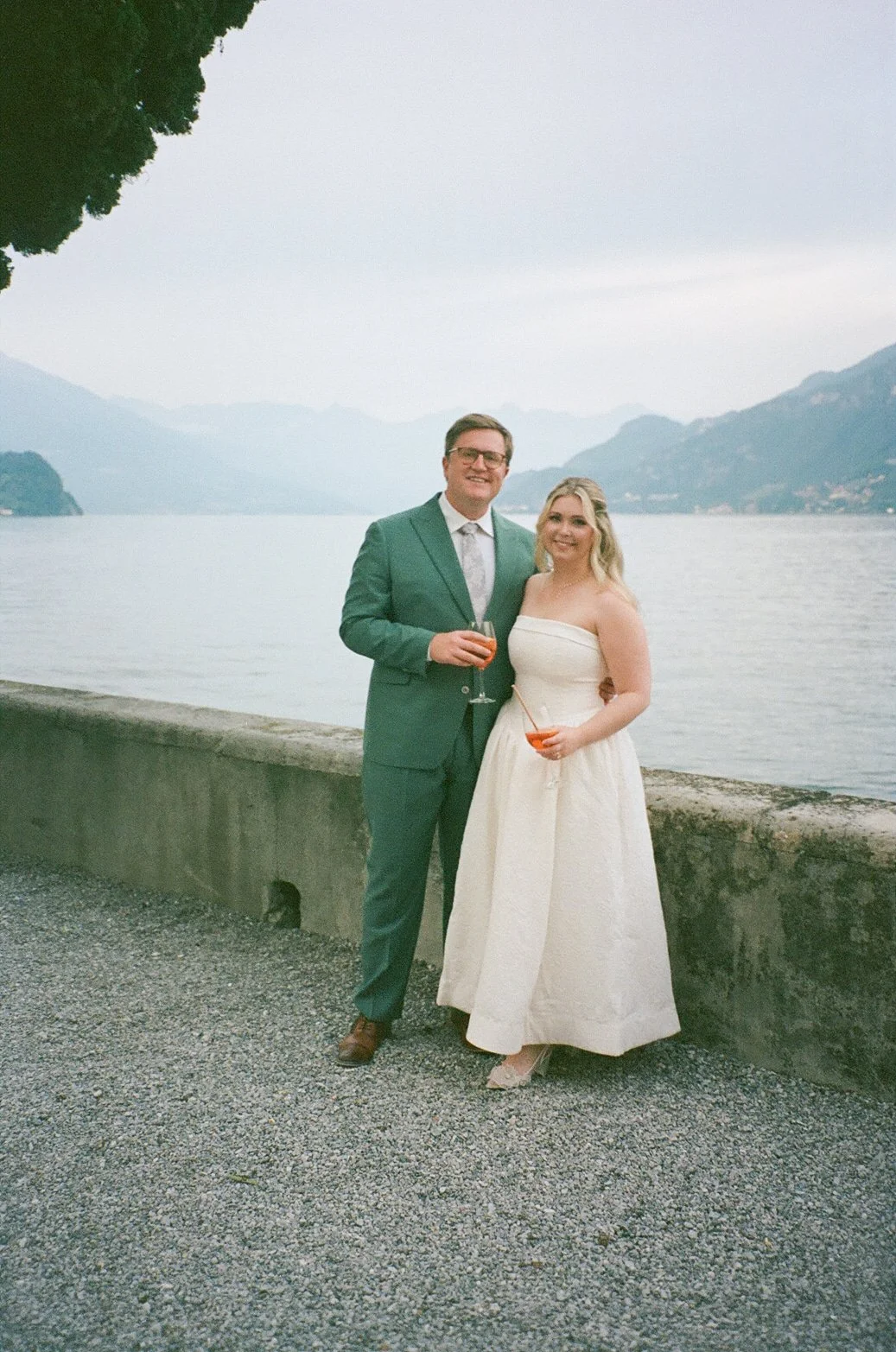 a couple poses at villa aura del lago in bilagio, lake como italy at their wedding rehersal