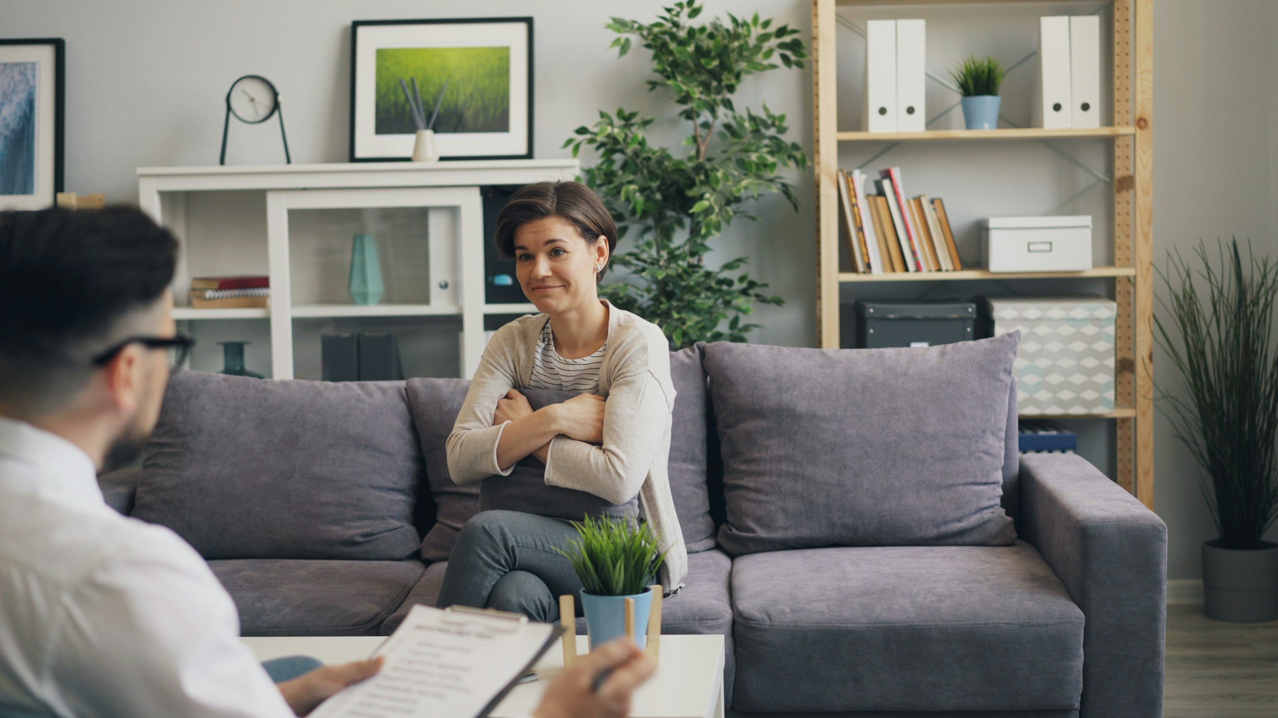 Client sitting on couch for therapy for panic attacks in Reston, VA