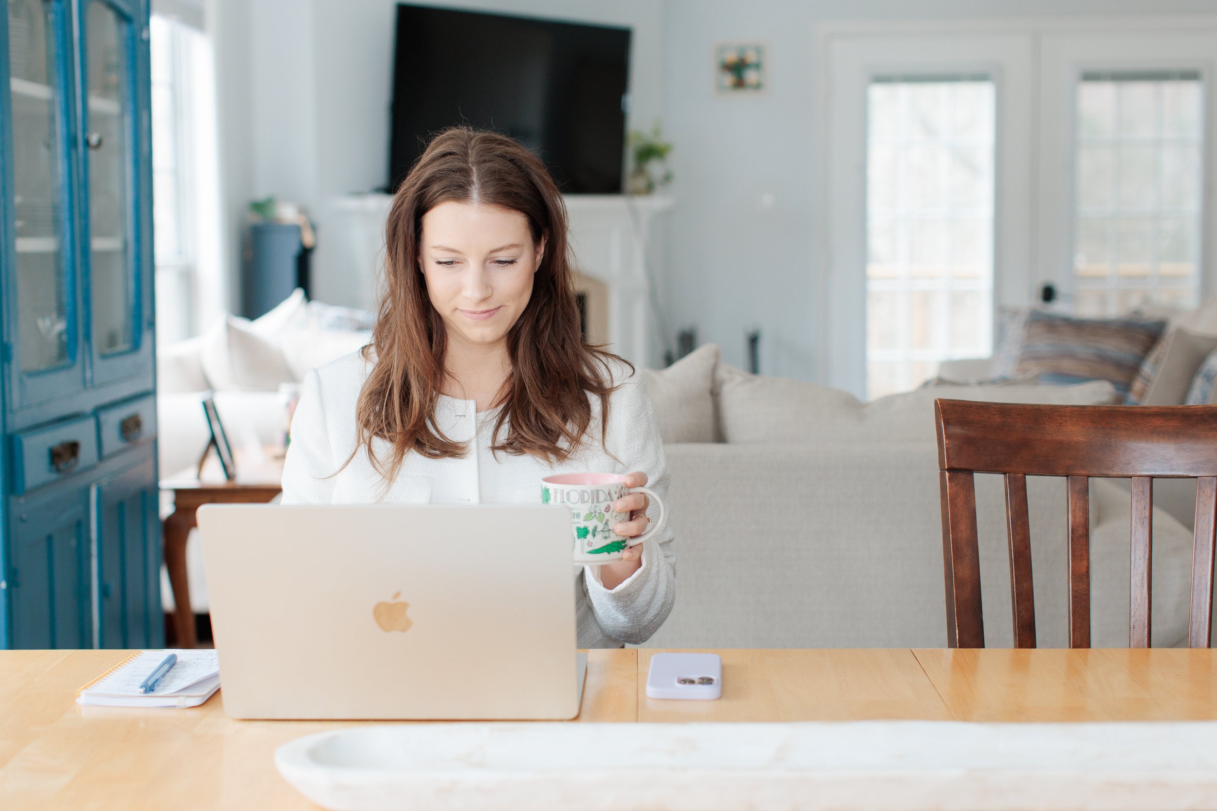 Therapist for panic attacks drinking coffee at table in Reston, VA