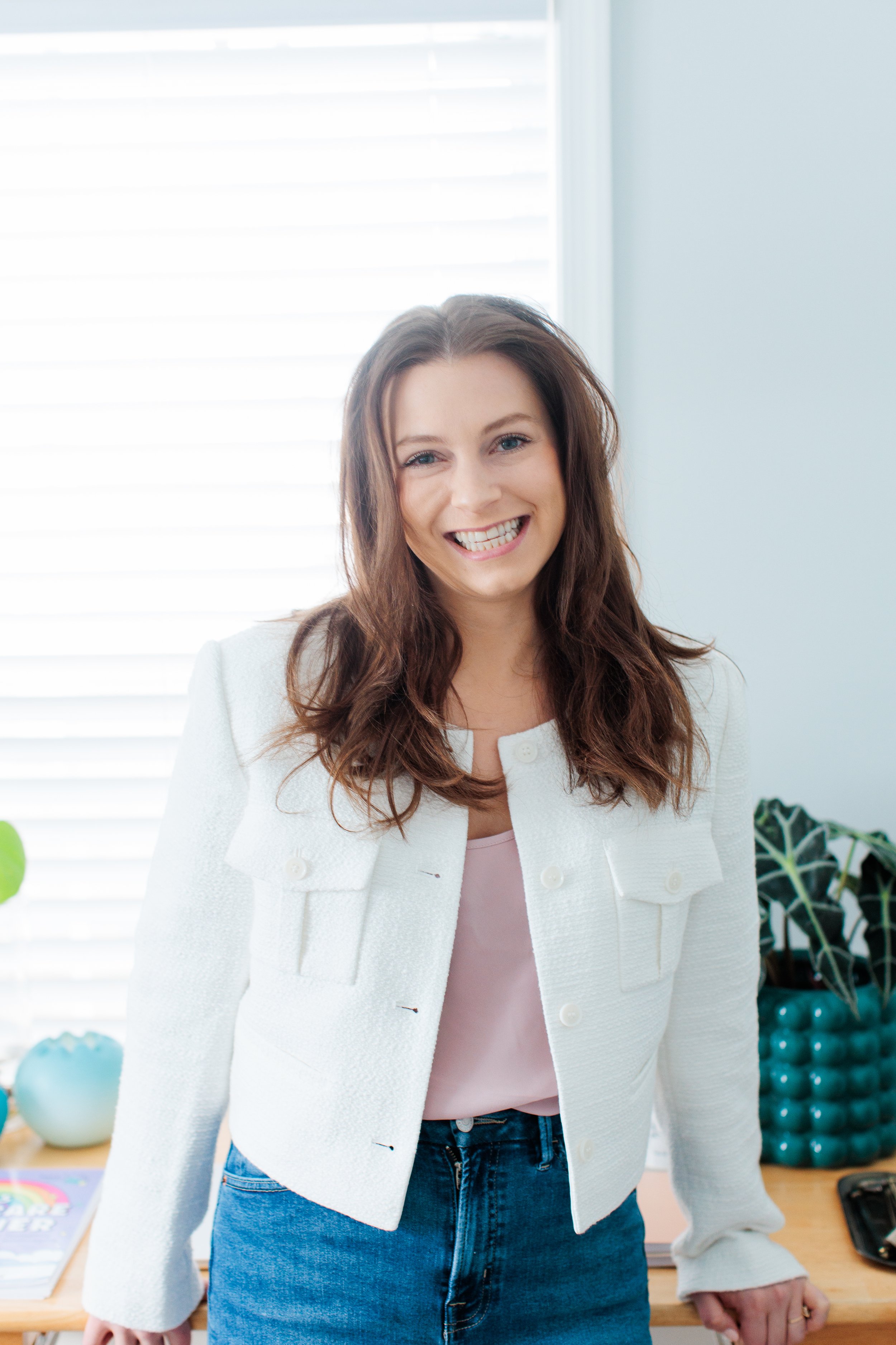 Therapist for panic attacks standing and smiling in office in Reston, VA