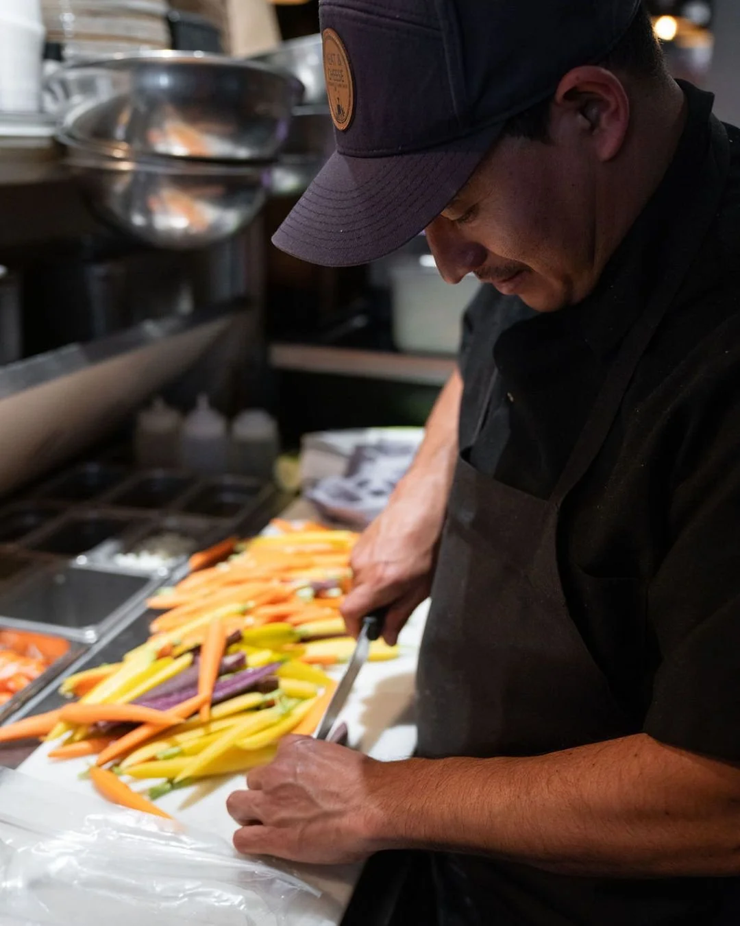 Our lovely salad chef bringing color and care to every plate.
#AspenEats #FreshProduce #MeatAndCheese