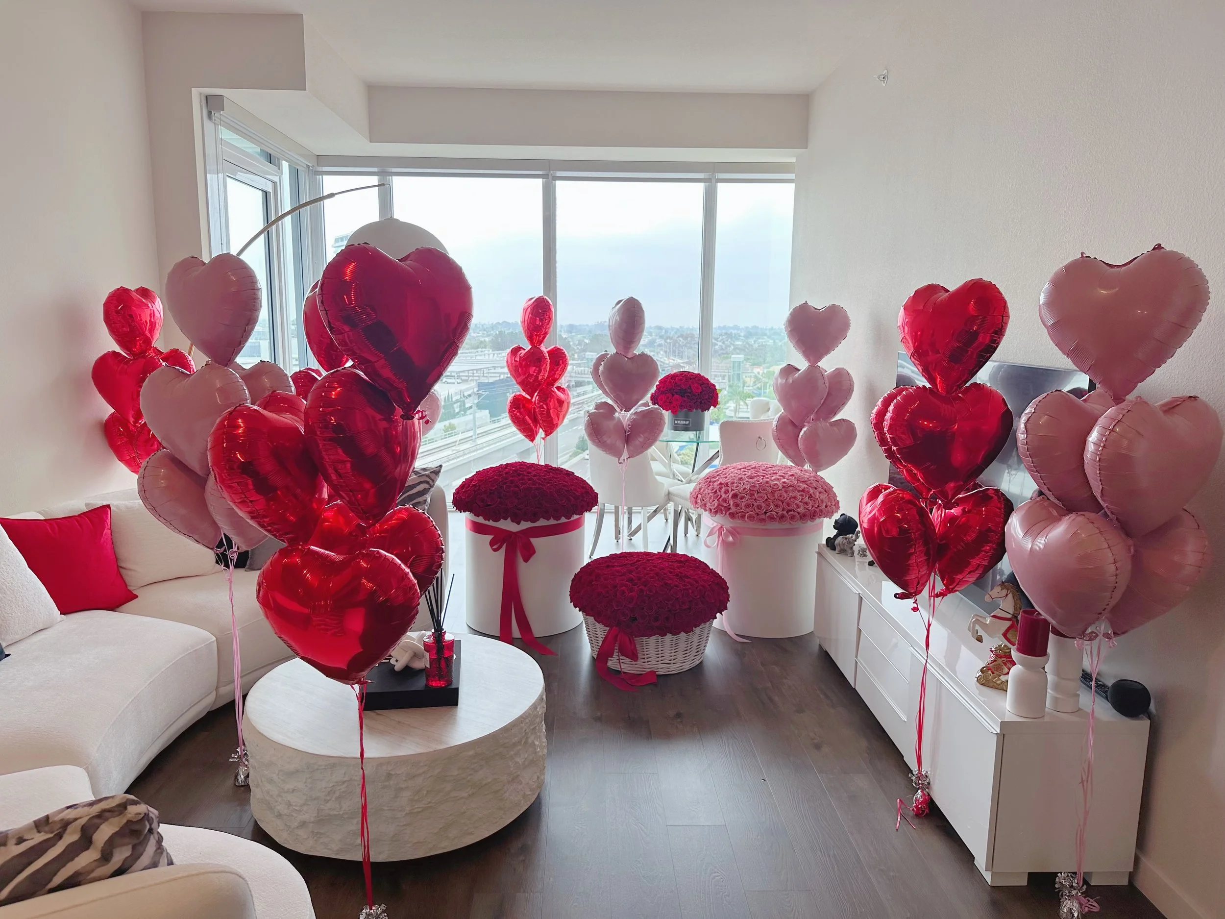 Hundreds of Roses and heart balloons.