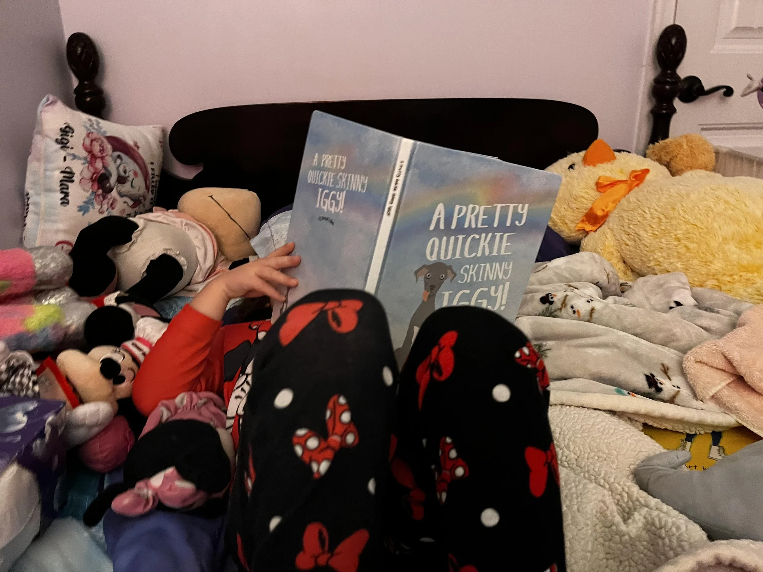 Kid reading A Pretty Quickie Skinny Iggy! on a bed