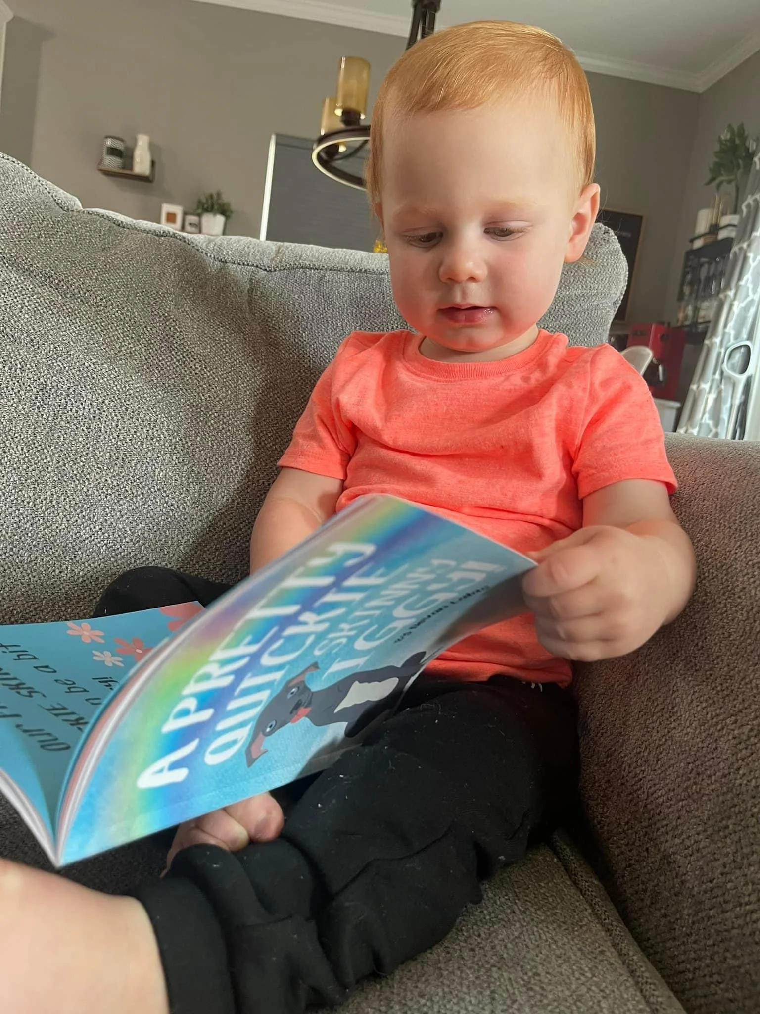 Kid reading A Pretty Quickie Skinny Iggy! on a couch