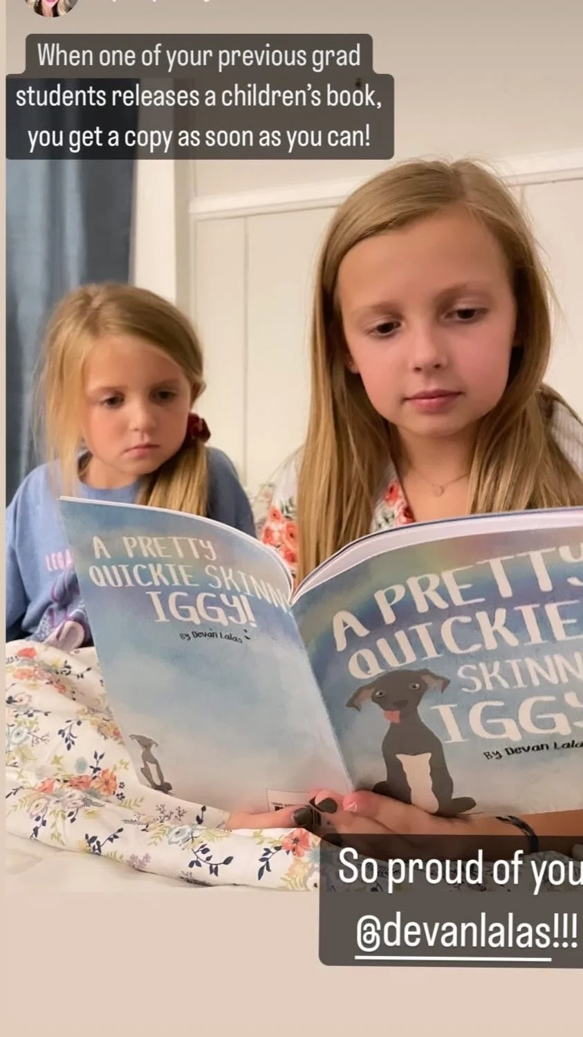 Sisters reading A Pretty Quickie Skinny Iggy! in bed.