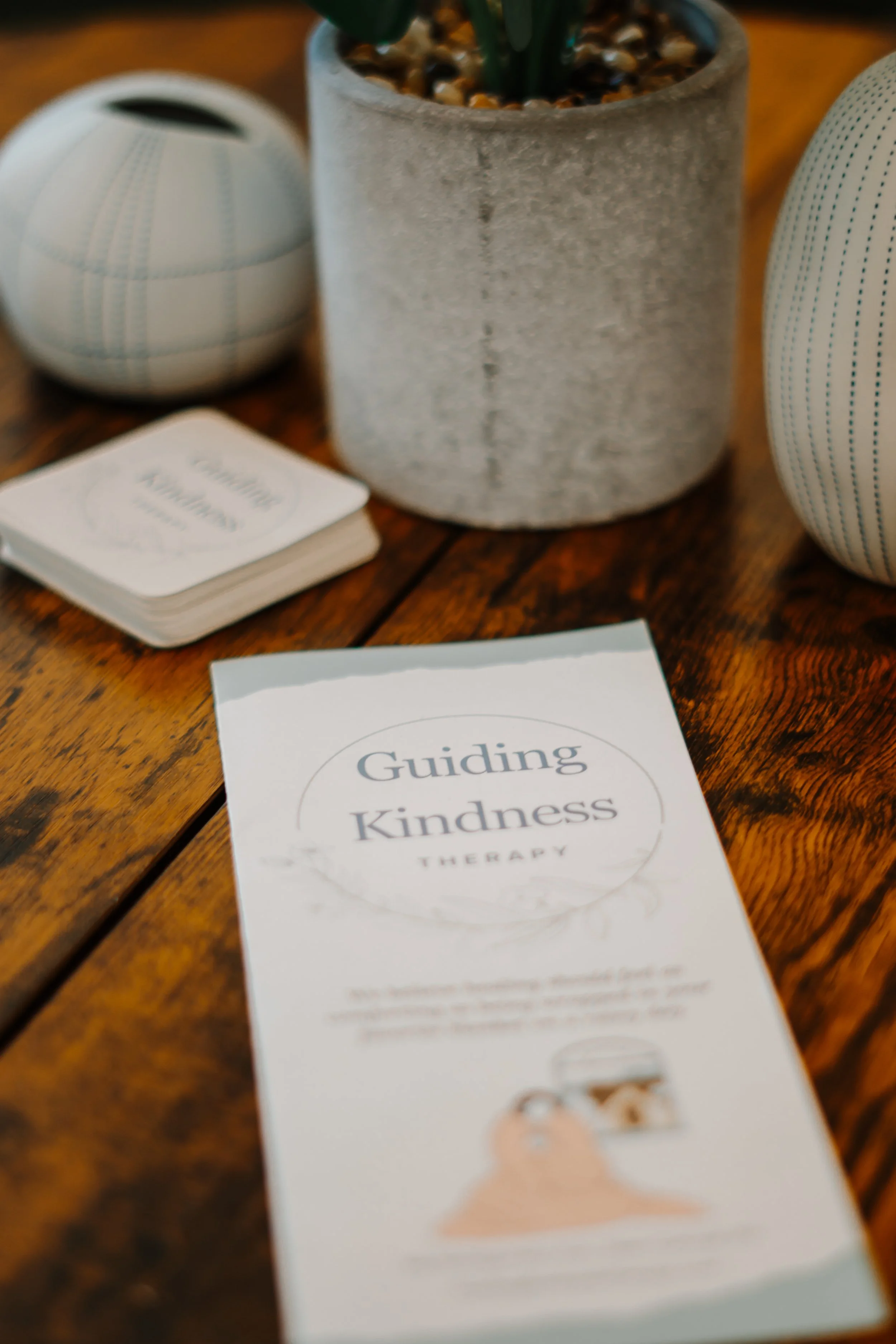 Guiding Kindness Therapy, a Philadelphia mental health office showcases a pamphlet on their desk.