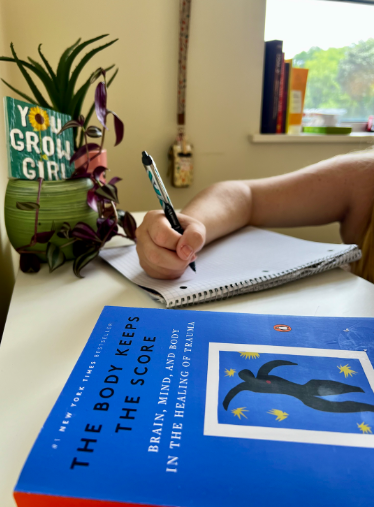 Guiding Kindness Therapy office in Bala Cynwyd PA for life transitions and parenting identity, picture shows book in foreground with hand writing in background.