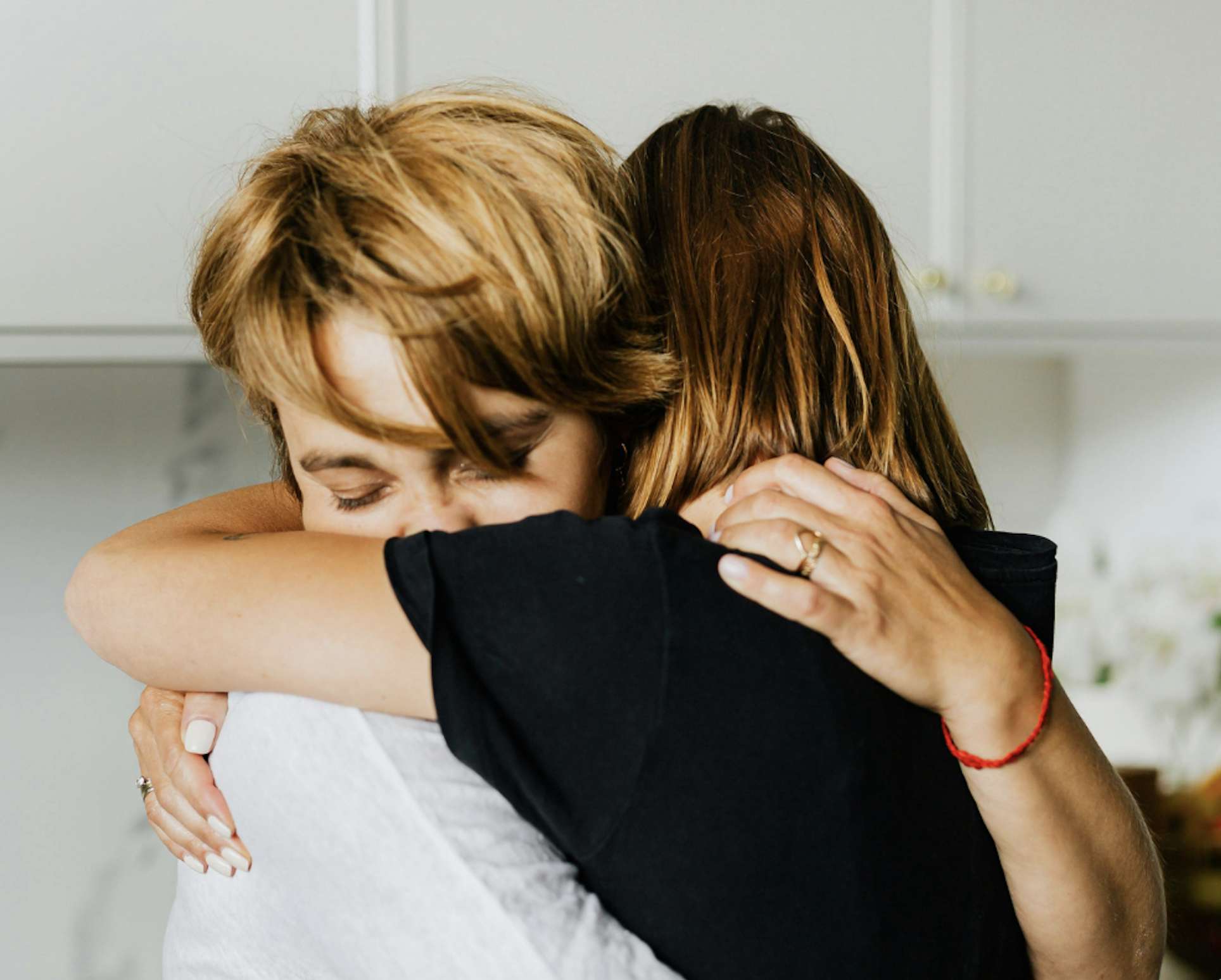 Two women embracing in a moment of support, reflecting compassion and connection in IFS therapy.