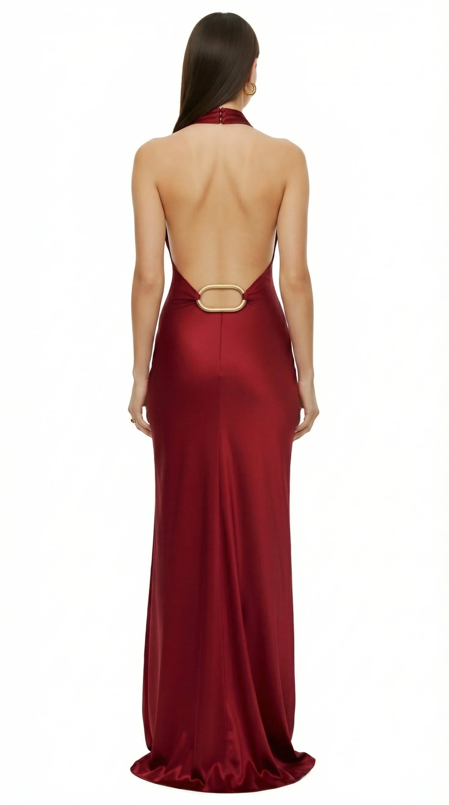 Back view of a woman in a long, red, backless satin gown with a gold ring detail at the waist.