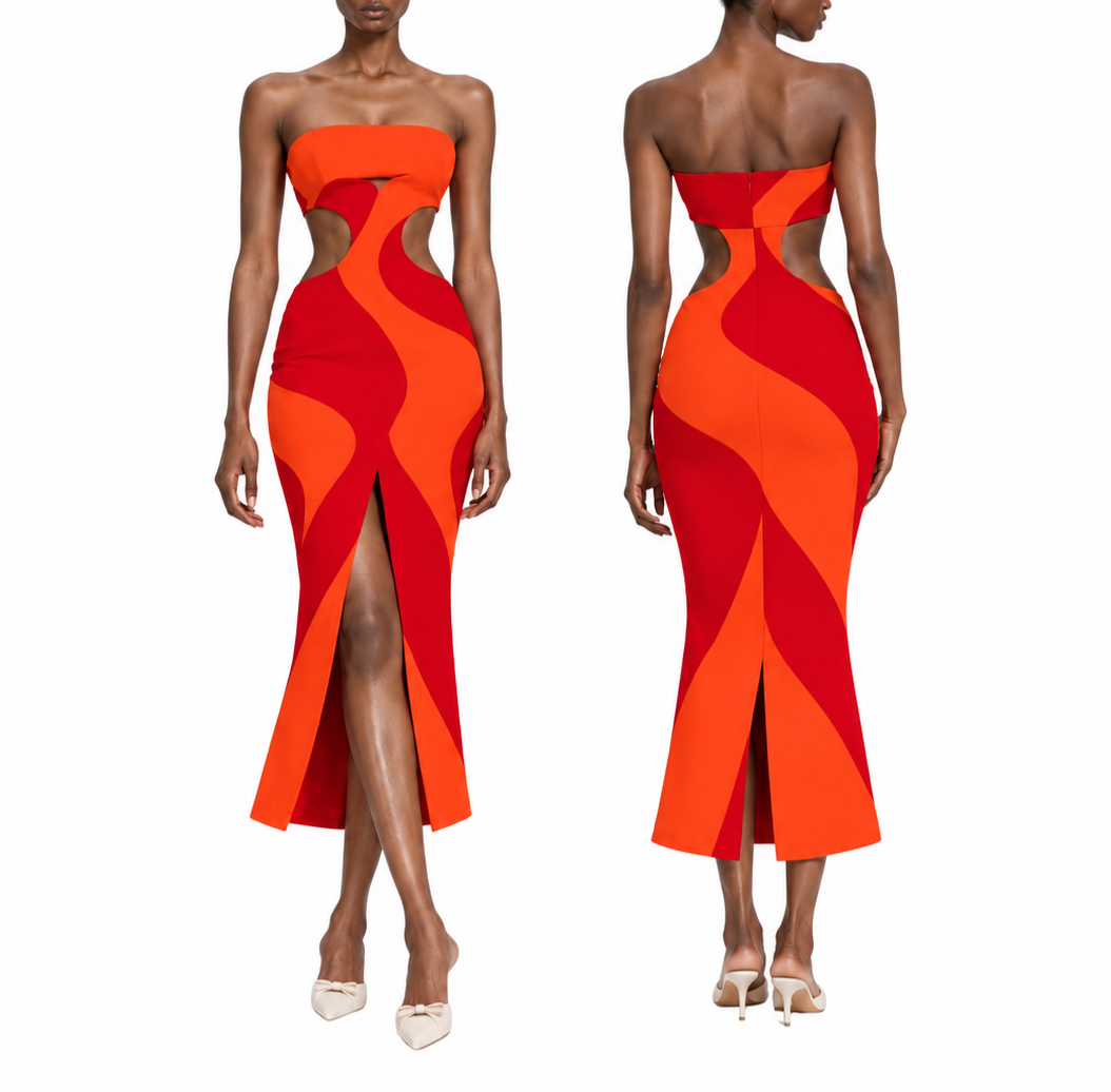Front and back view of a woman wearing a red and orange patterned strapless dress with cutouts at the sides and a slit in the front, paired with white high heels.