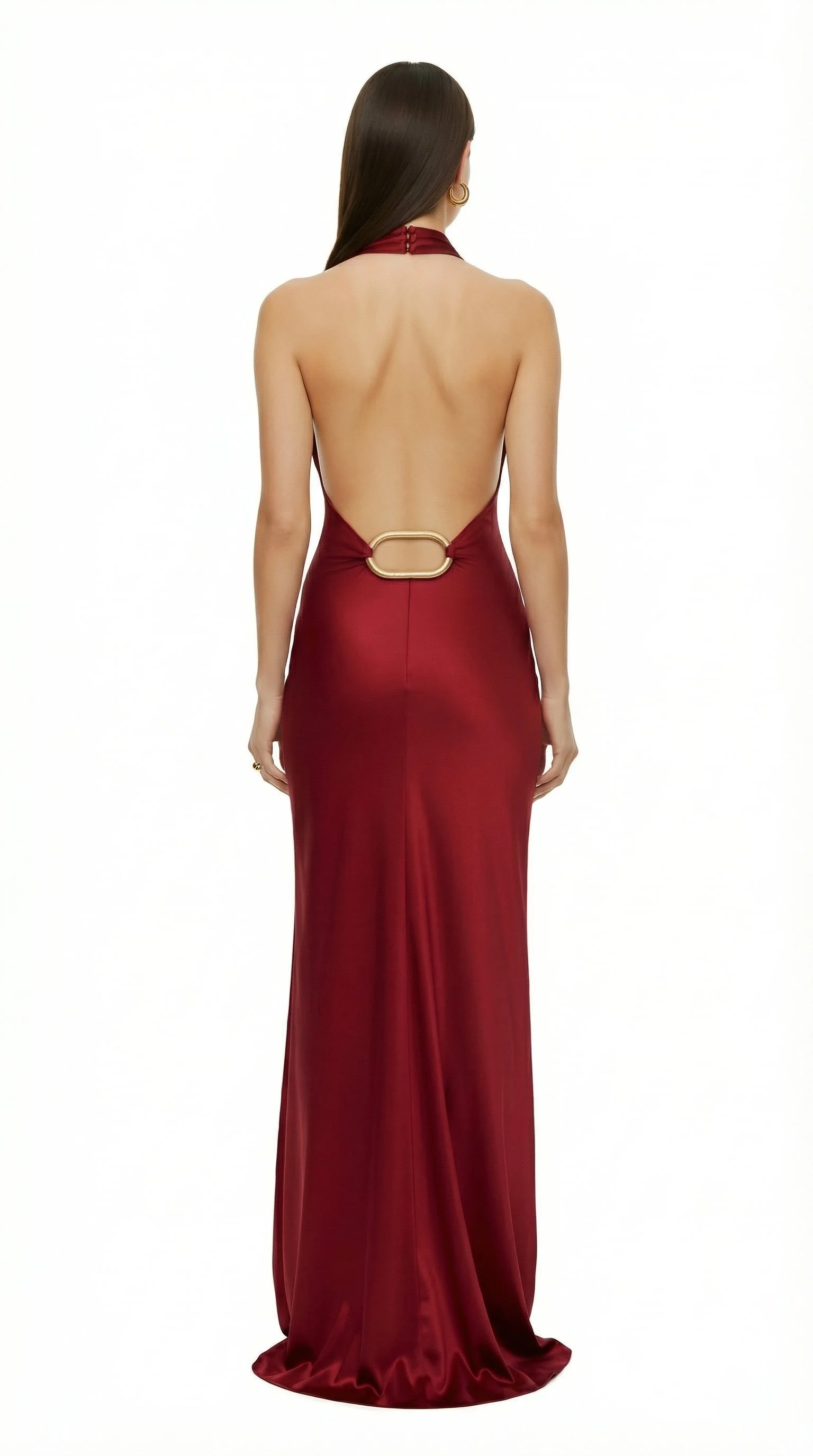 Back view of a woman in a long, elegant, backless red gown with a gold belt detail.