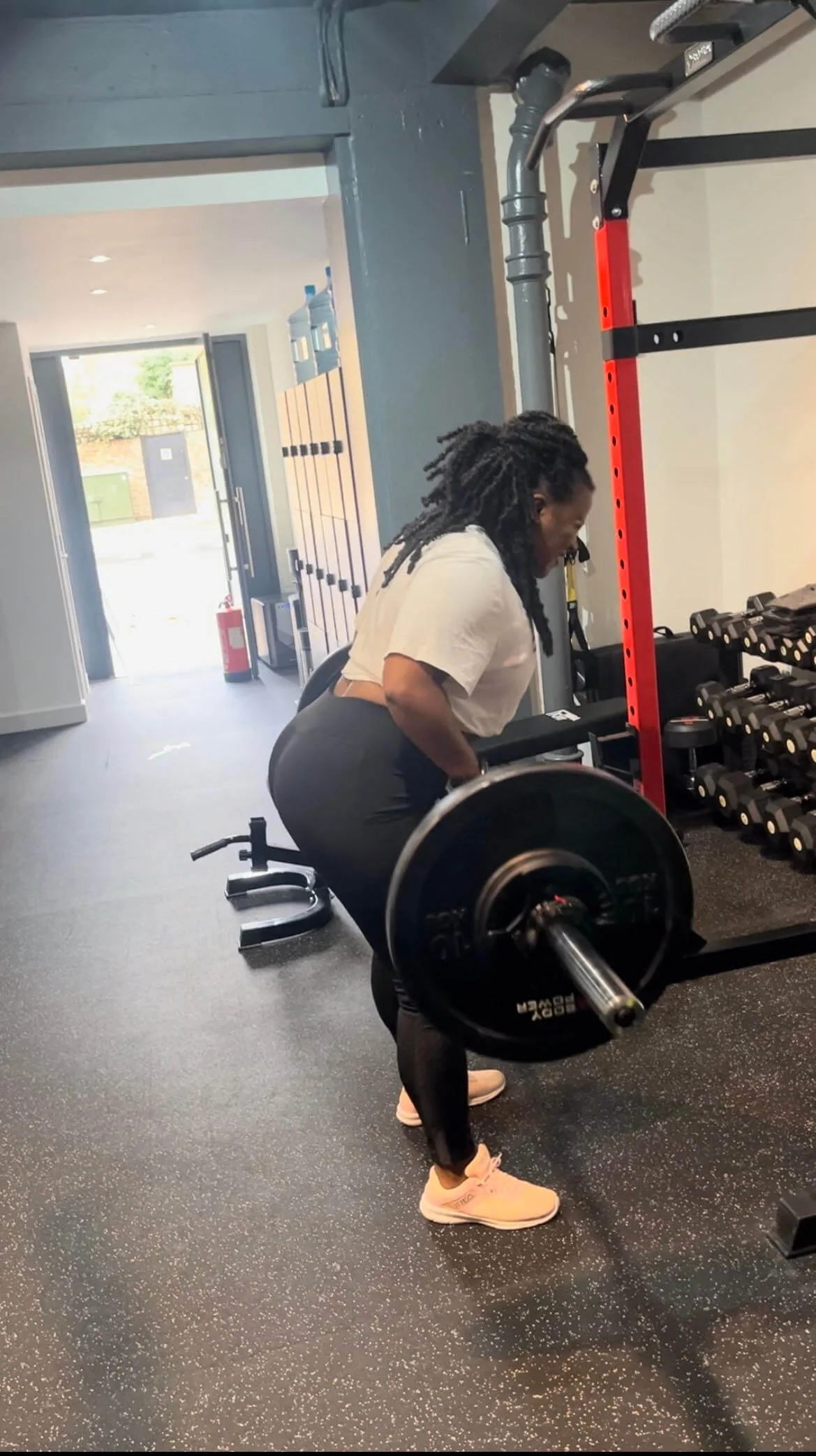 A female client performing a deadlift at a private gym near Camden & Euston during a personal training session