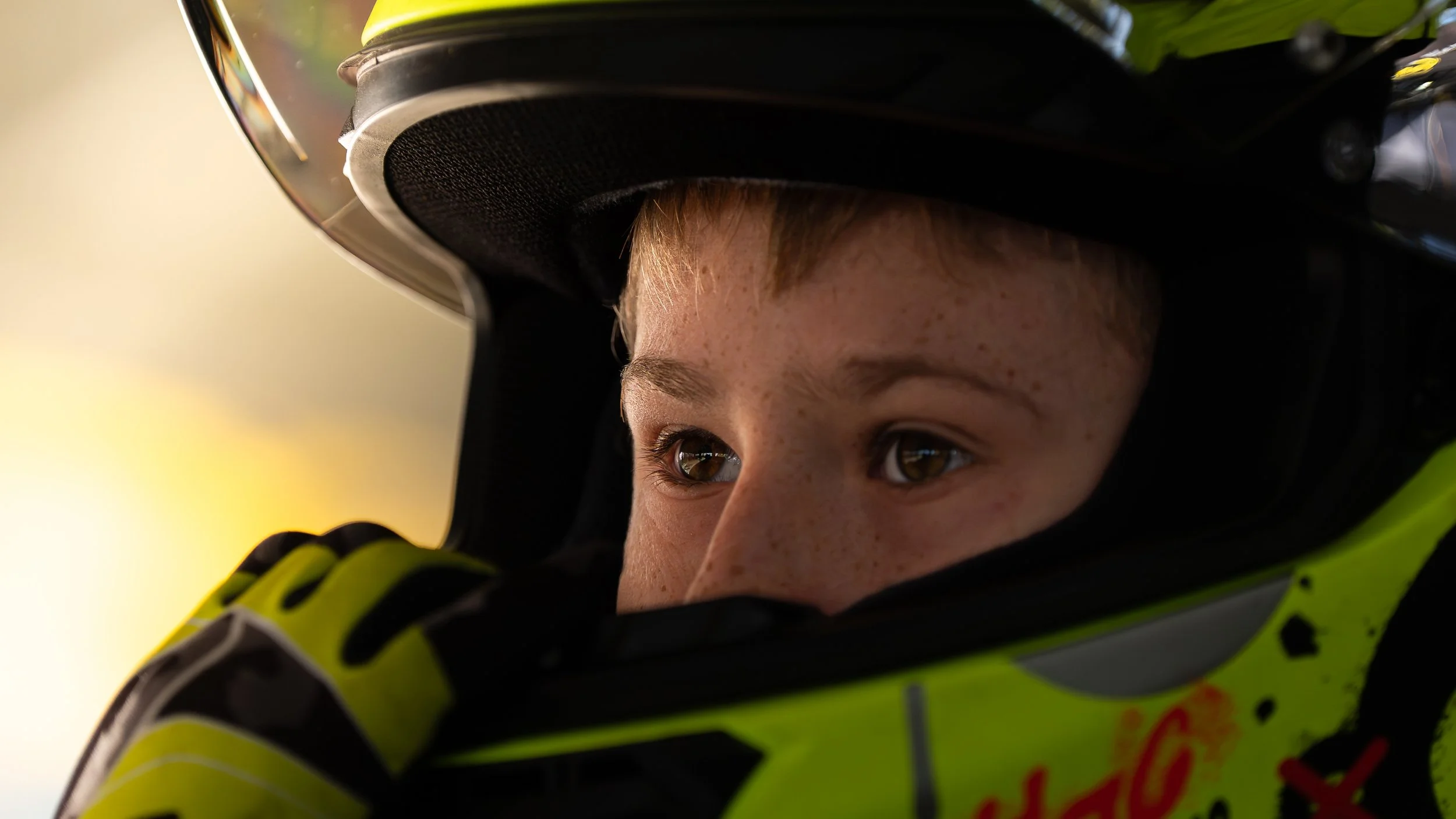 Close-up of a person wearing a helmet, with their eyes looking upward.