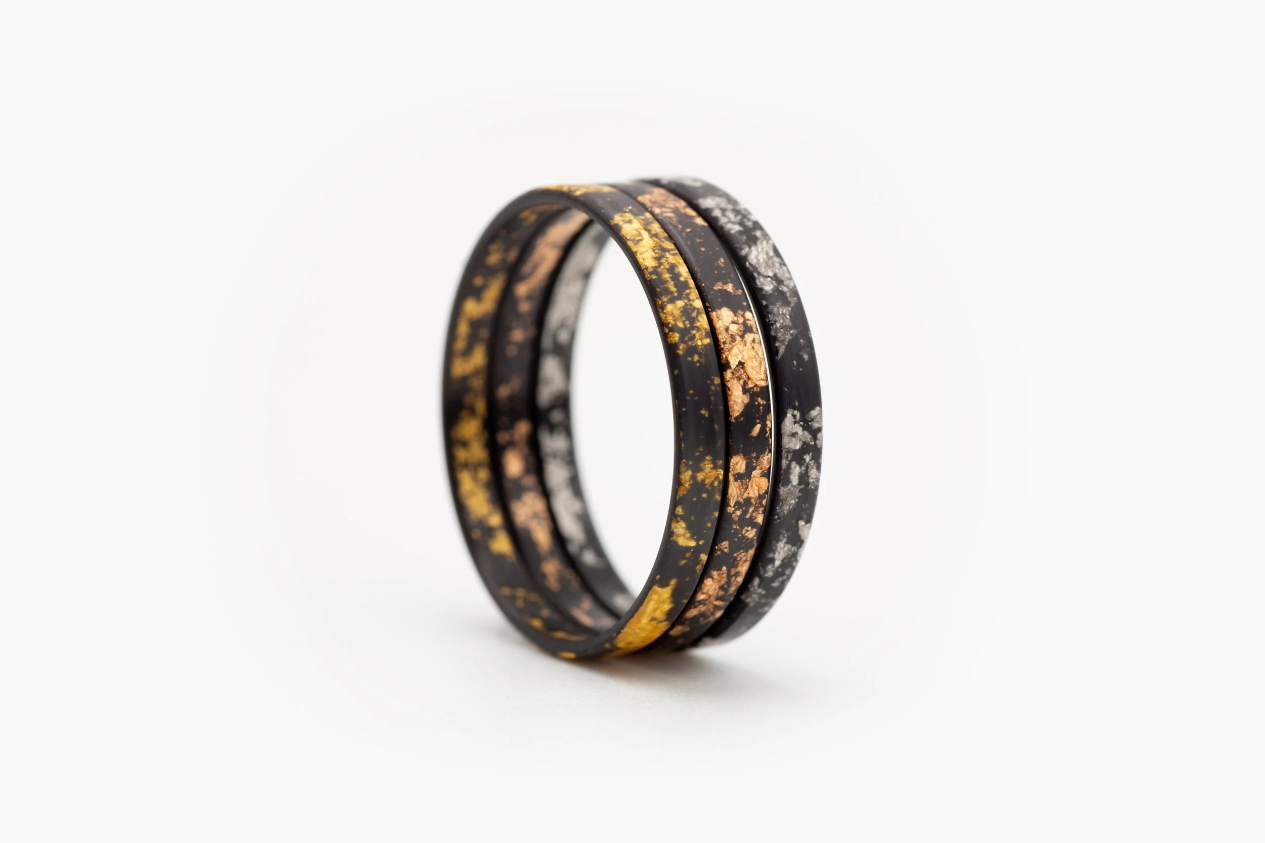 Singularity_carbon gold rings trio-1.jpg
