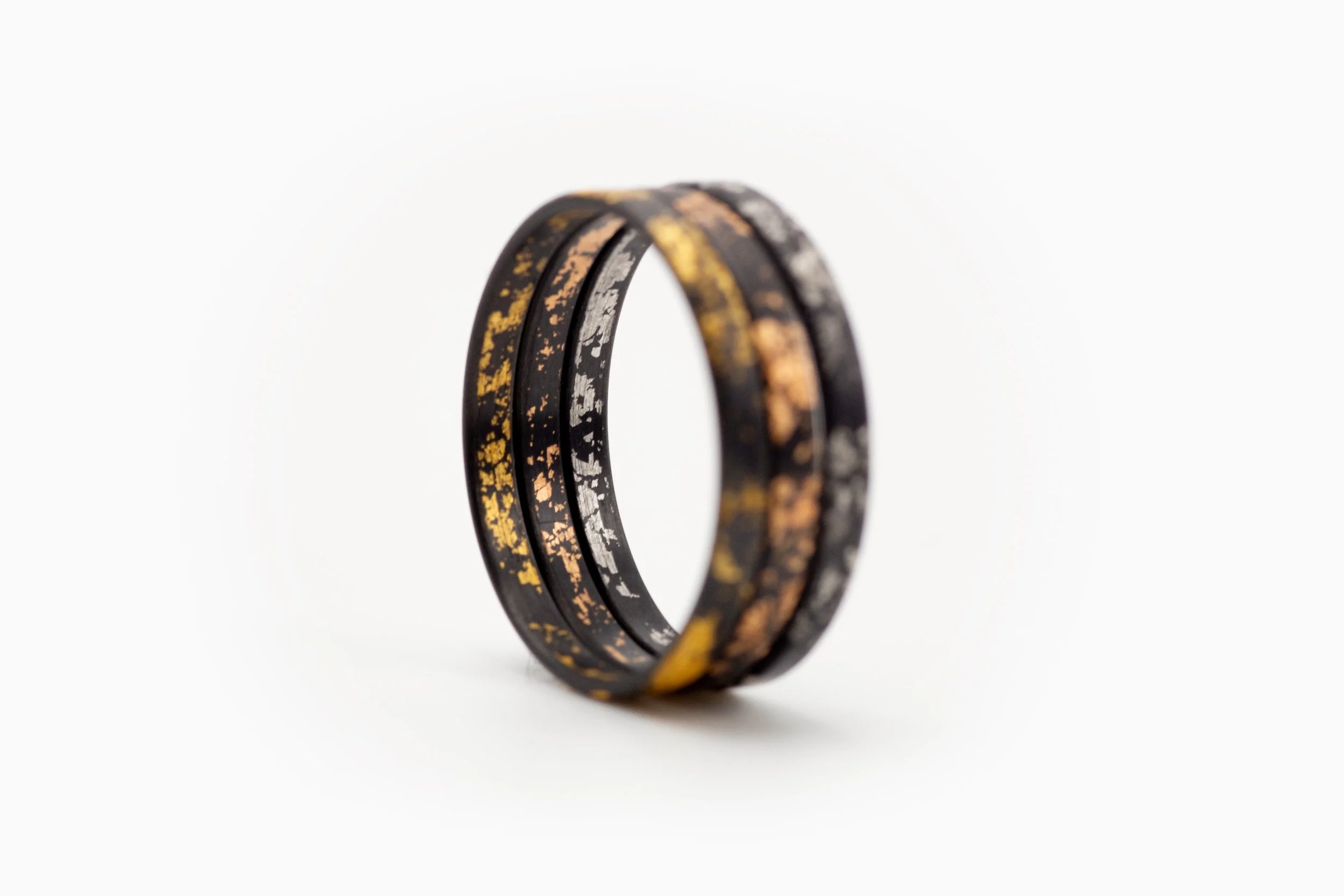Singularity_carbon gold rings trio-2.jpg