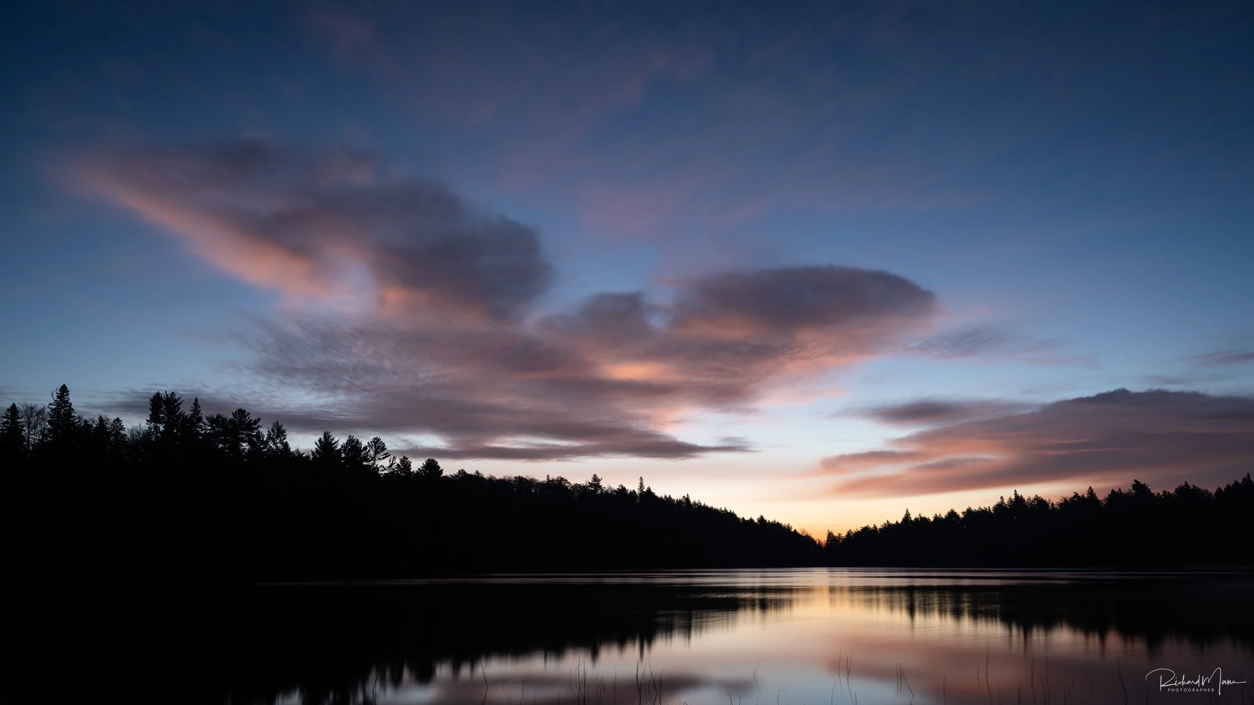 Clouds lighting up during the blue hour on Canoe Lake in Algonquin Park