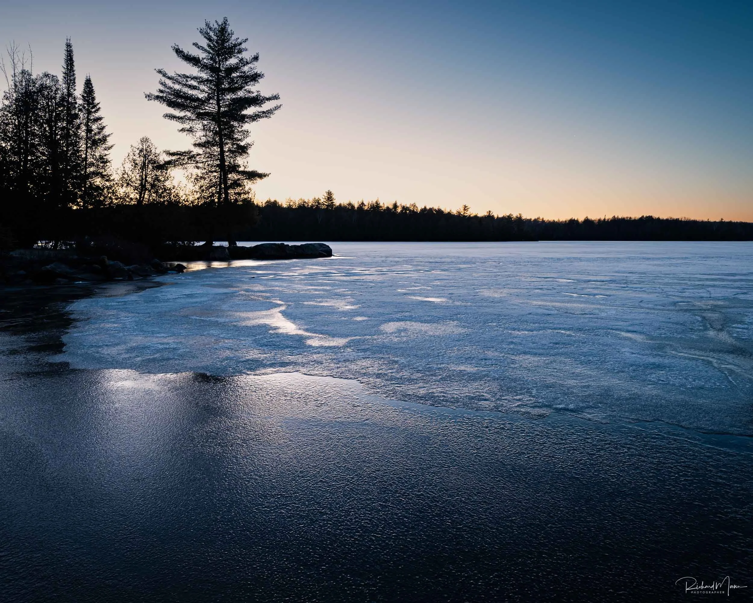 Icy morning during the blue hour on Smoke Lake in Algonquin Park
