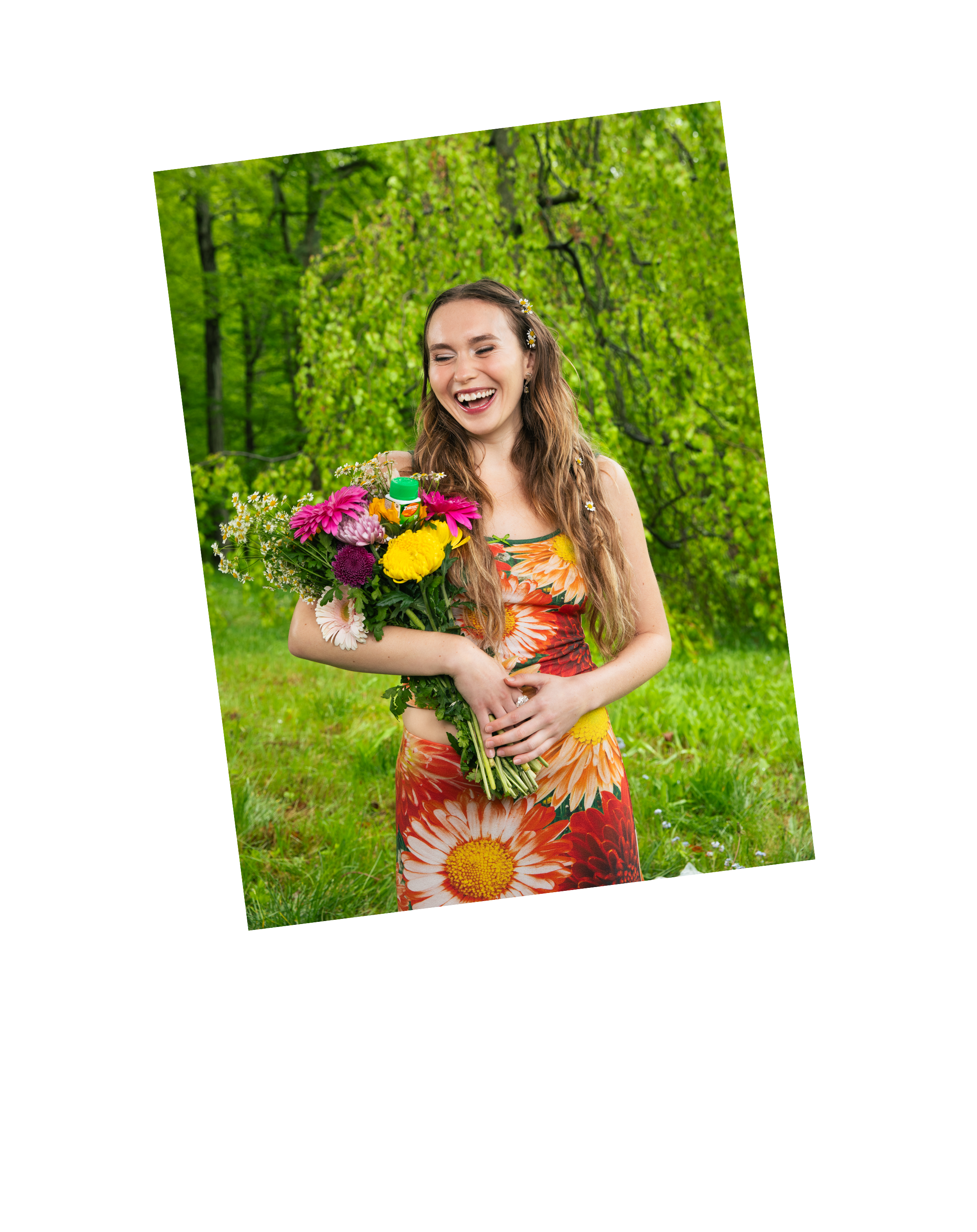 A young woman with long brown hair, smiling and holding a colorful bouquet of flowers and a ZYRTEC bottle.