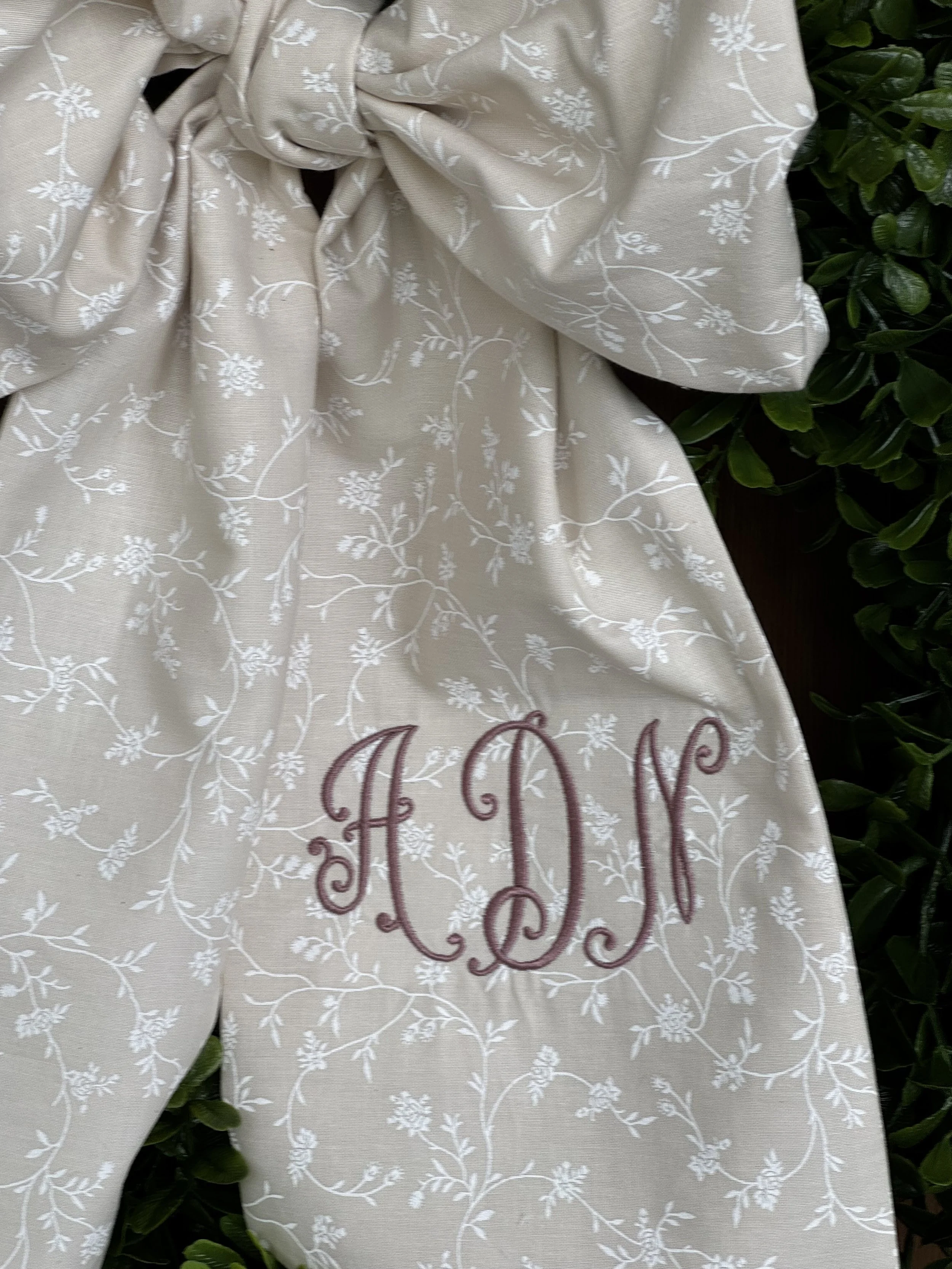 Monogram detail close-up Close-up of embroidered monogram on a handmade personalized fabric bow. (Copy)
