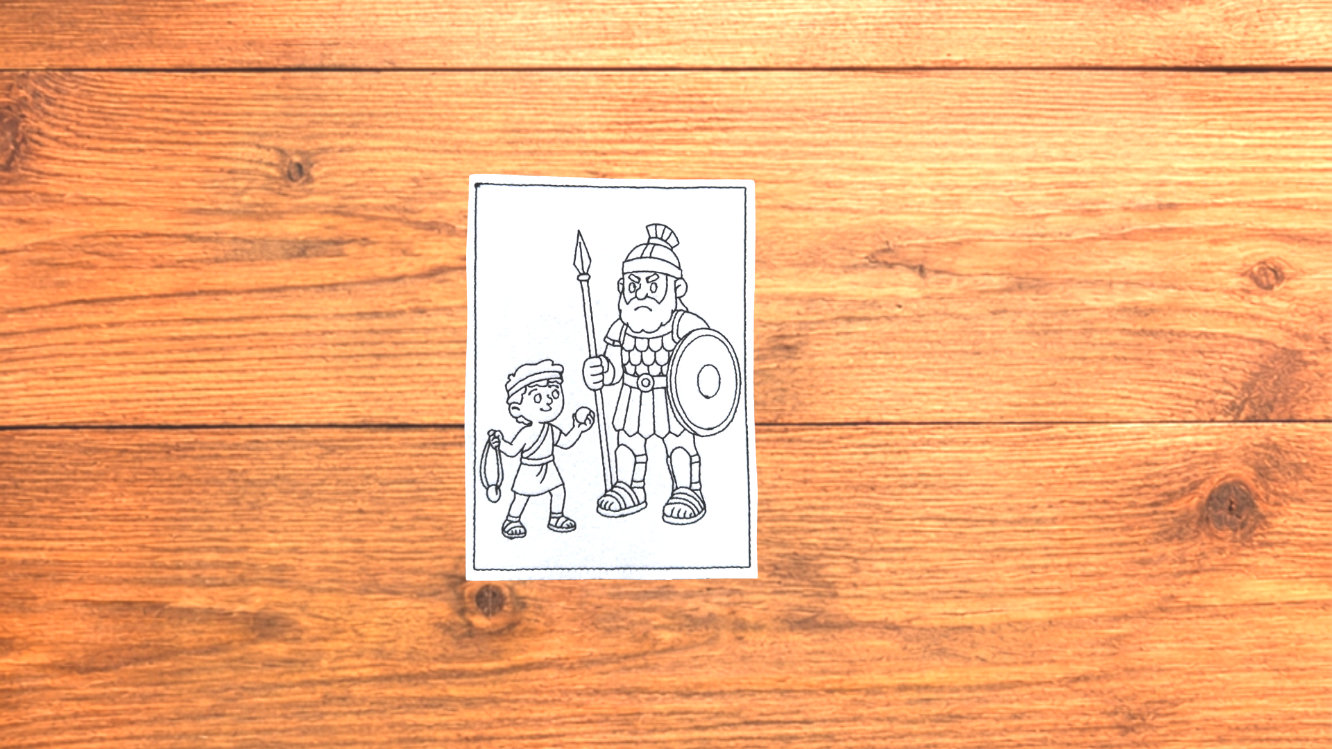 David & Goliath reusable Bible Story Coloring Cutie activity card on wooden background