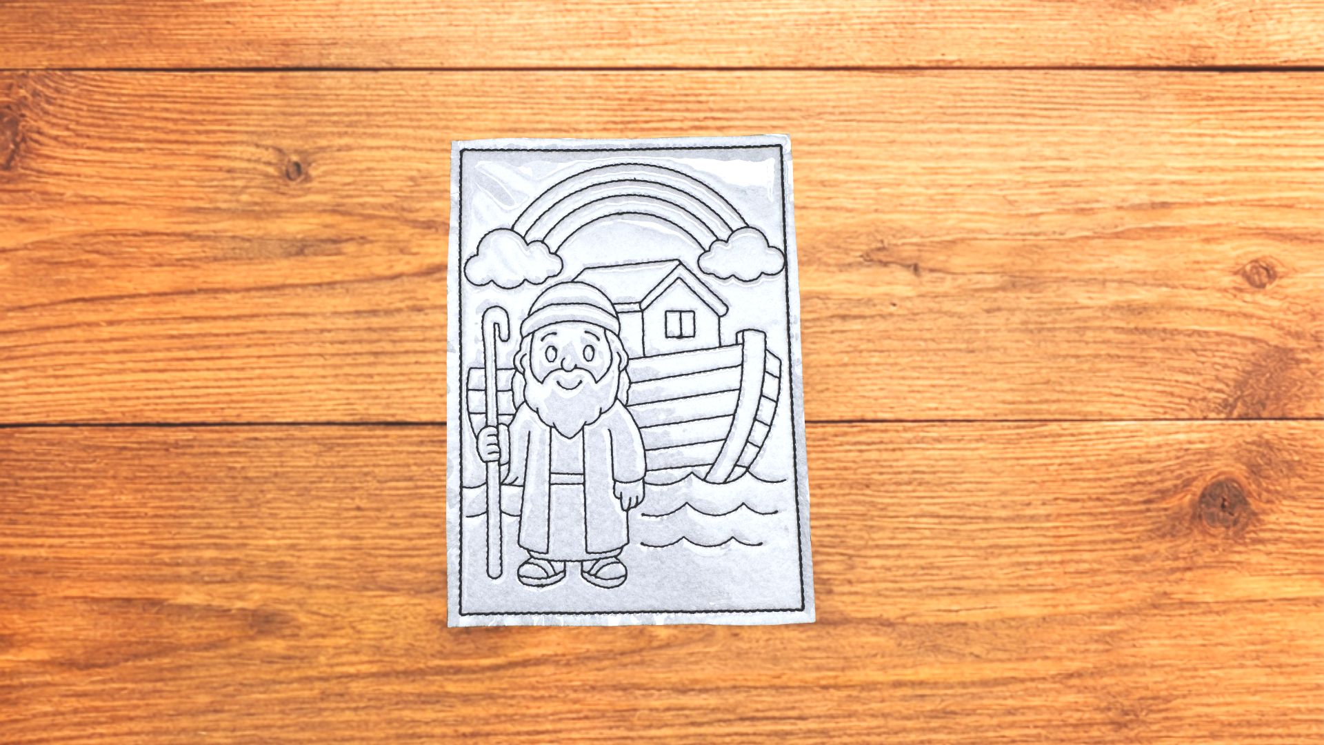 Noah reusable Bible Story Coloring Cutie activity card on wooden background