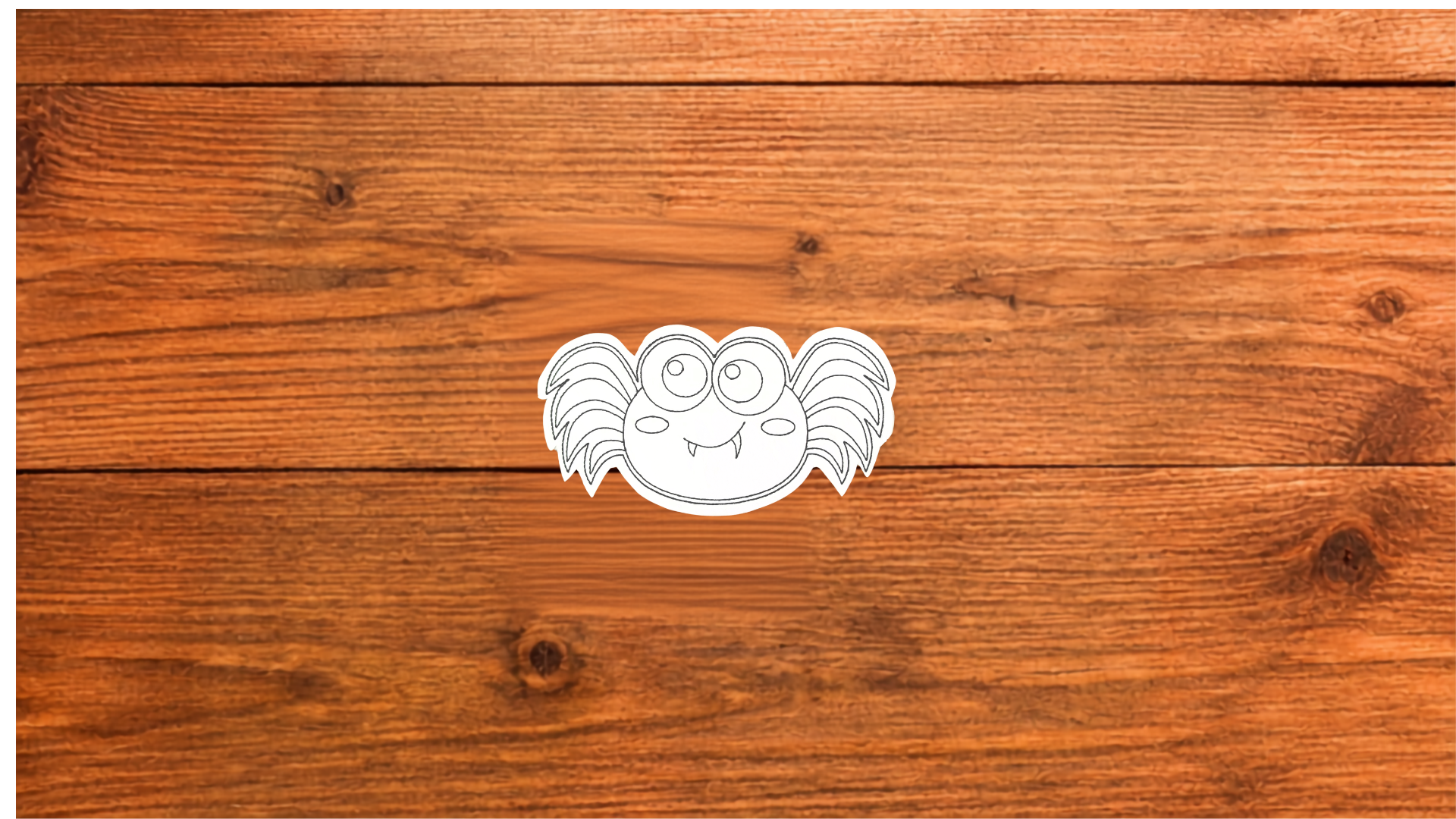 Silly Spider Reusable smiling spider Coloring Cutie with large eyes, playful fangs, and stitched outlines on a wooden background. (Copy)