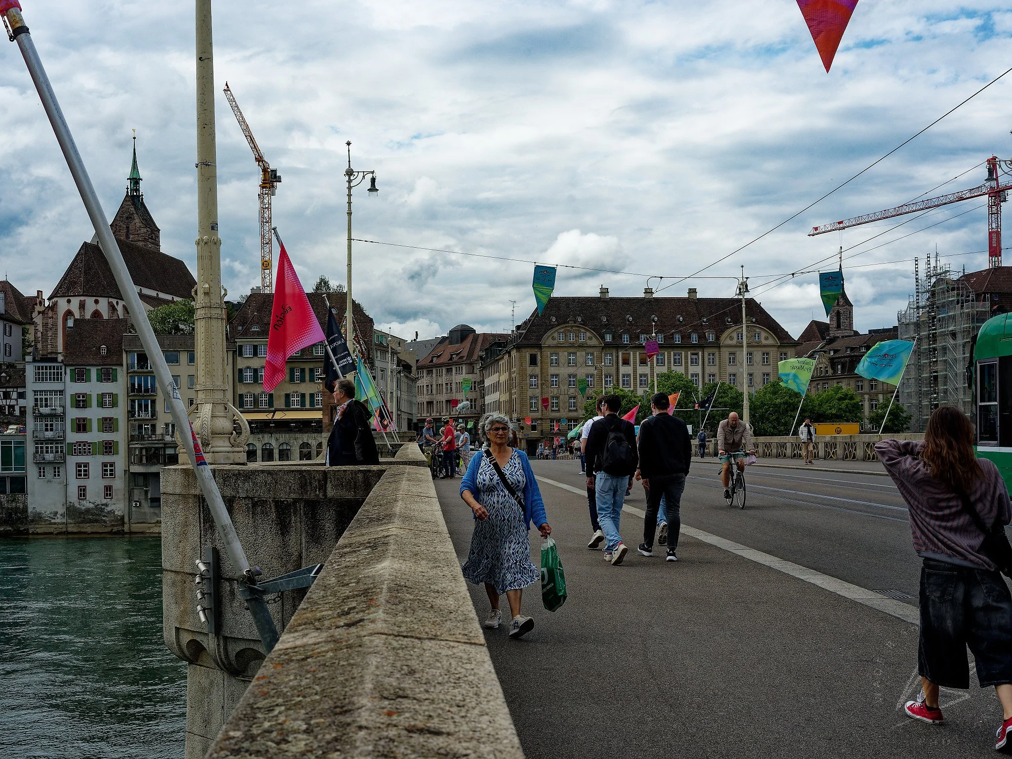 Mittlere Brücke (Middle Bridge) over the Rhine, Basel, Switzerland, decorated with Eurovision Song Contest 2025 flags and banners. One of Basel's oldest and most iconic Rhine crossings, with the medieval Old Town visible on the left bank. Basel, Swit