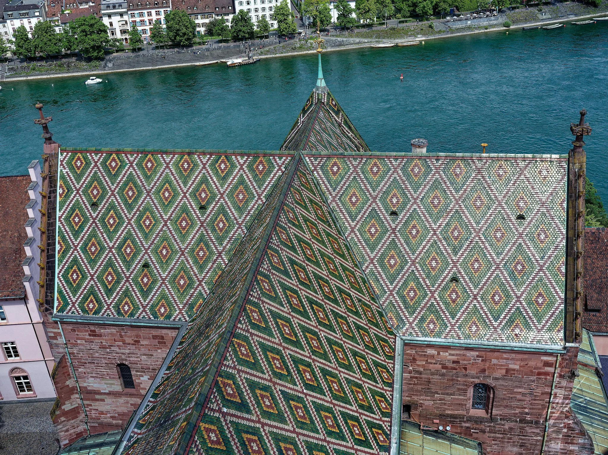 
The iconic diamond-patterned glazed tile roof of the Basler Münster (Basel Cathedral), photographed from the cathedral tower, Basel, Switzerland. The colourful geometric tile work is one of the most distinctive features of the medieval cathedral, se
