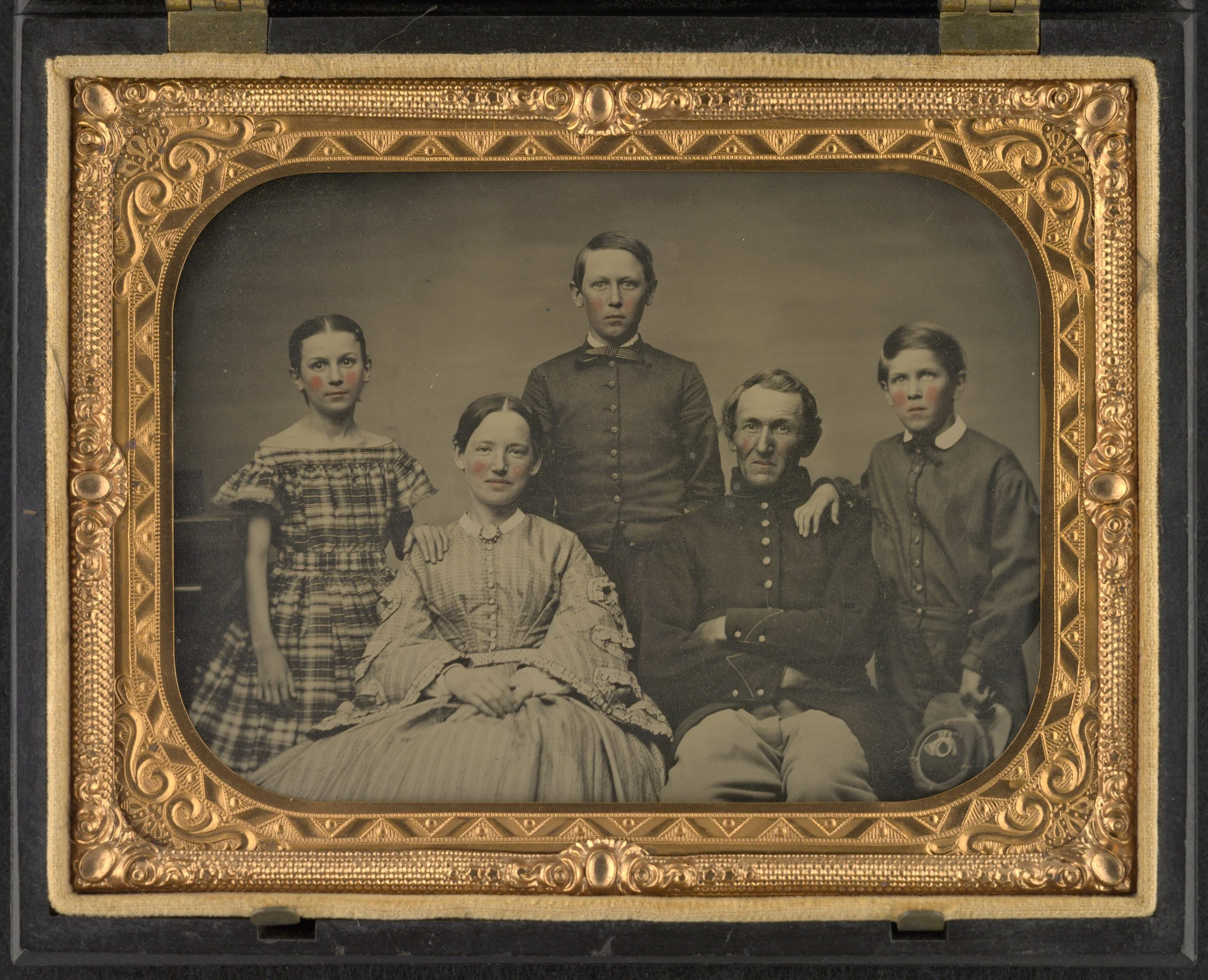 Hand-colored Civil War ambrotype in a gilt case: a Union soldier seated beside his wife, with a daughter in a plaid dress and two sons standing behind them. Liljenquist Family Collection, Library of Congress.