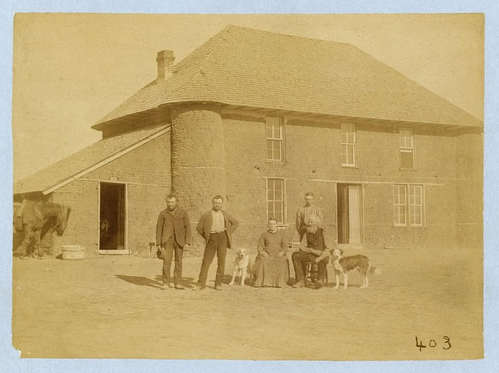 The Haumont family stands in front of their two-story sod house on French Table, Custer County, Nebraska, 1886. Photograph by Solomon D. Butcher, Library of Congress.