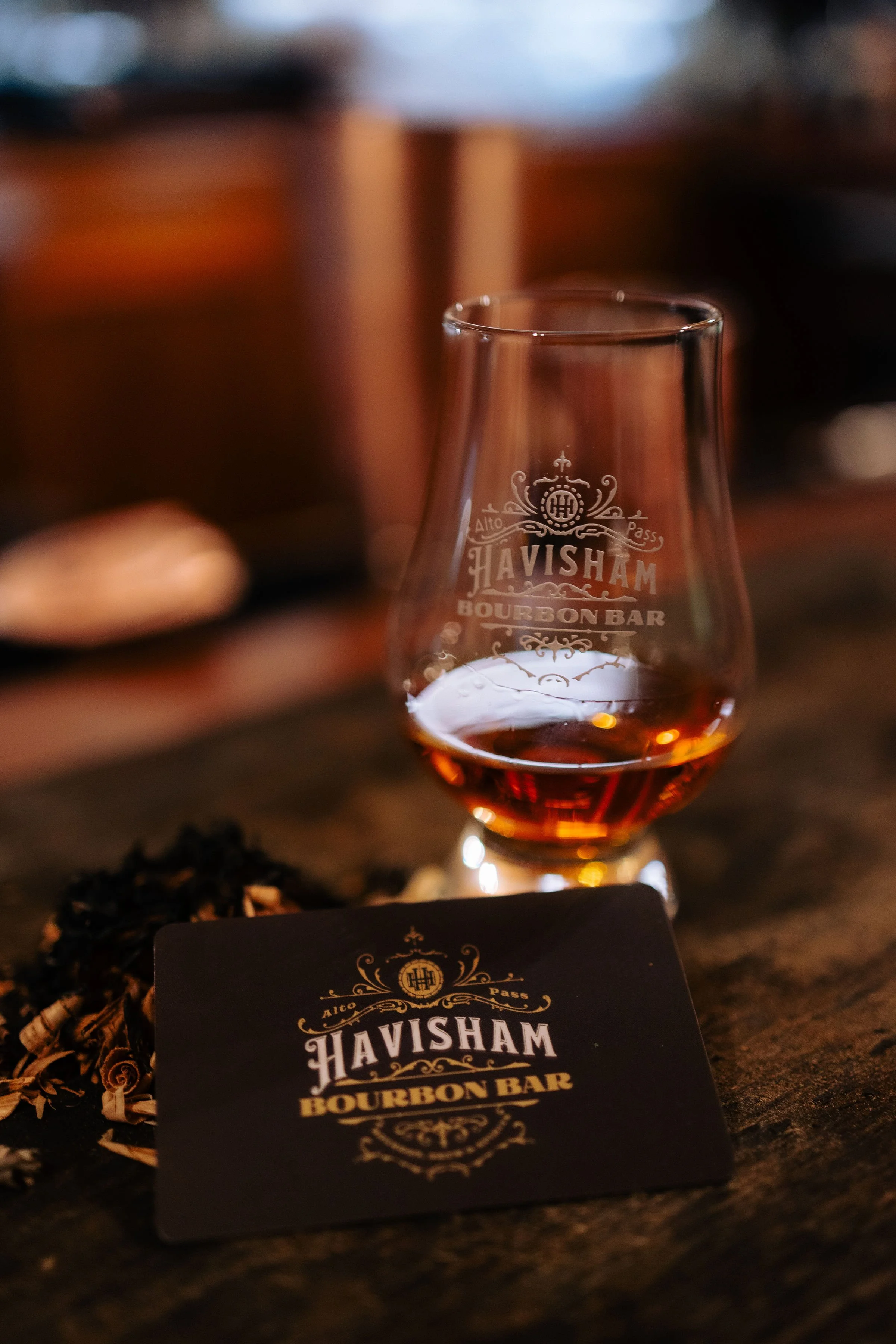 gift card next to a glass of bourbon