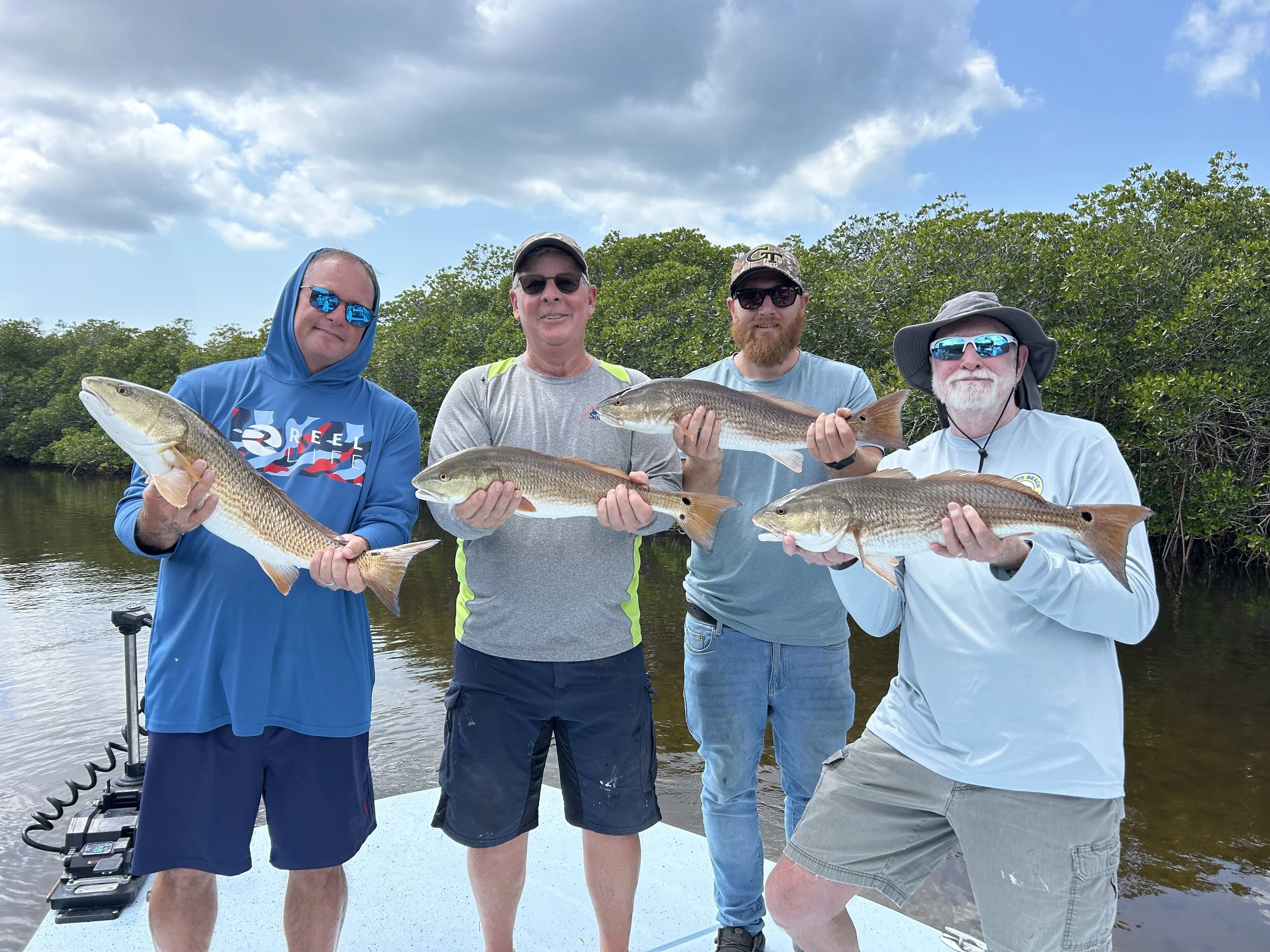 4 clients holding their catches