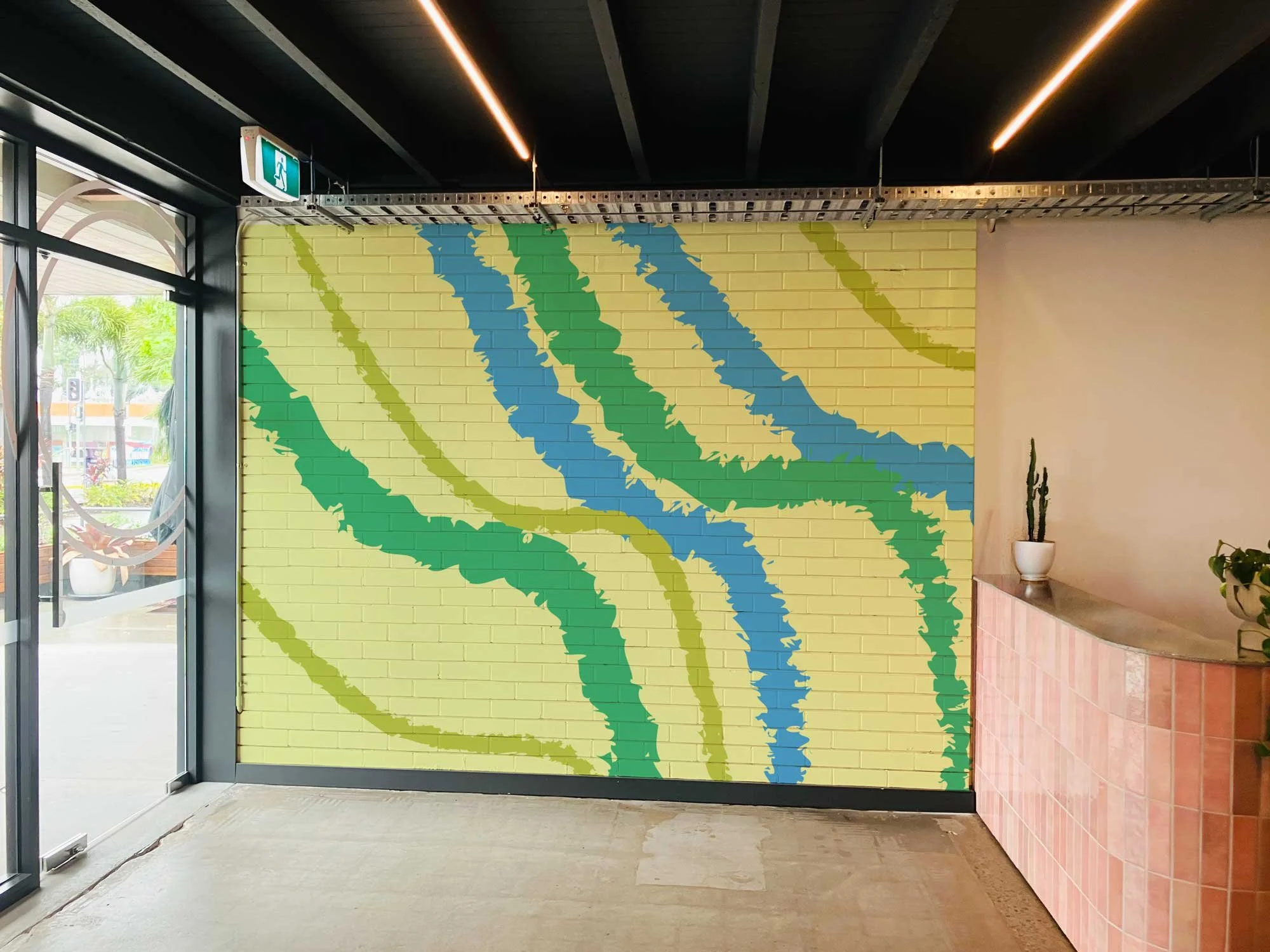 Indoor brick wall mockup for posters, murals, campaigns or large-scale artwork.