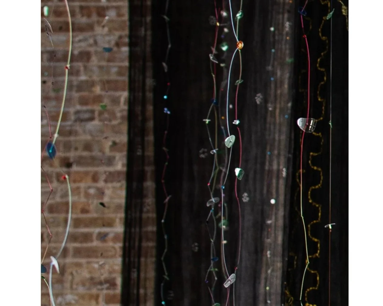 Atmosphere Strands, (detail) hand-cut post consumer plastic, beads, buttons, multi-color monofilament, lengths range from 72 to 144 in.