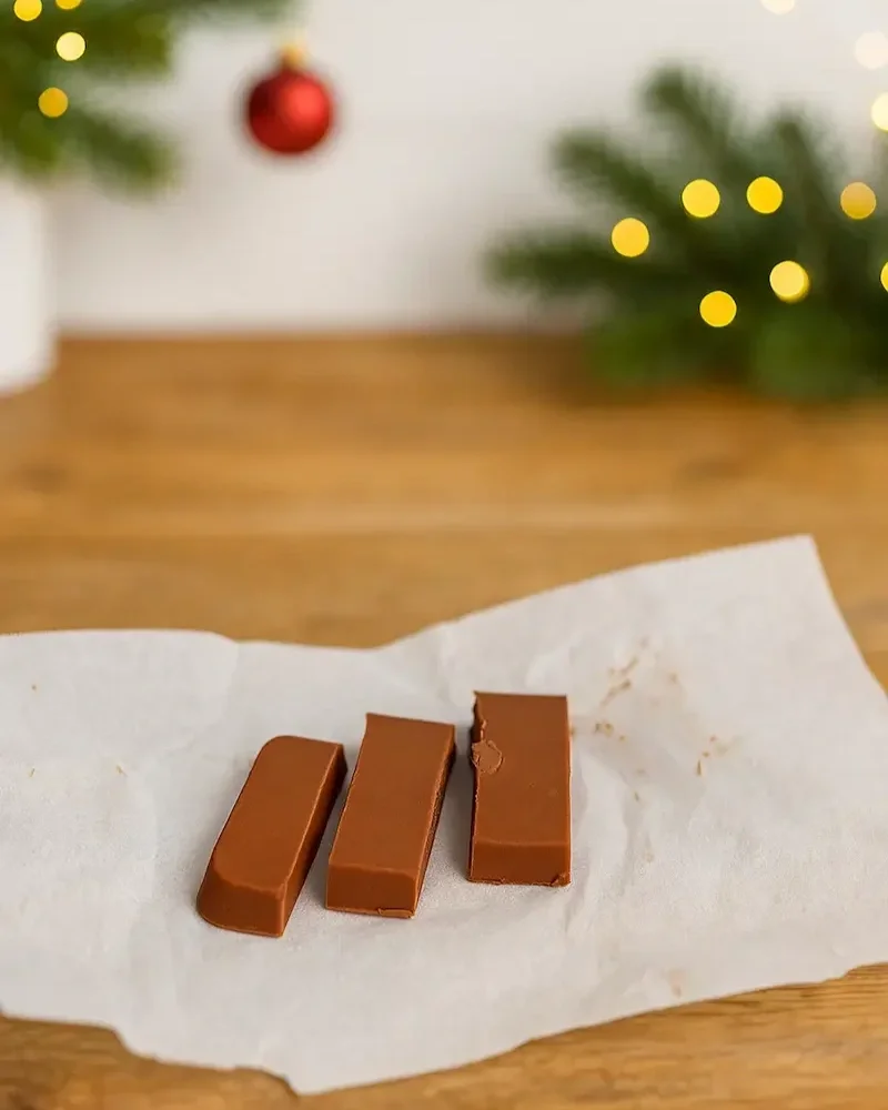 Creamy peanut butter fudge squares arranged on baking paper, ready for wrapping as a thoughtful homemade Christmas gift for women’s wellness.