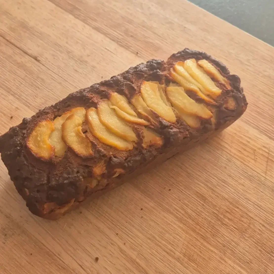 Whole gluten-free pear and honey loaf topped with sliced pear, spiced and baked until golden, perfect for autumn baking