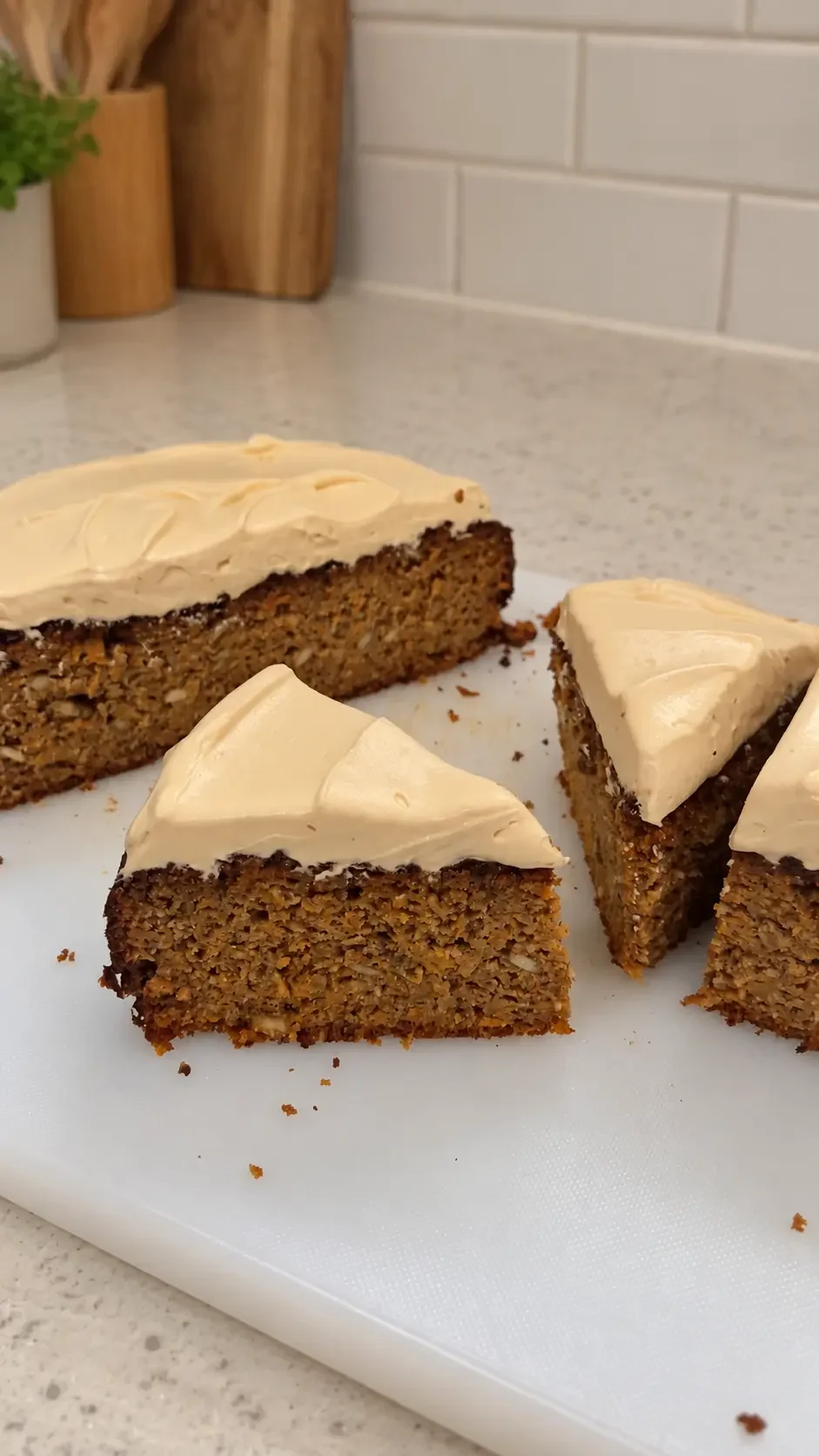 Close-up of the moist inside of a healthy carrot cake showing grated carrots, raisins and a soft almond meal crumb.