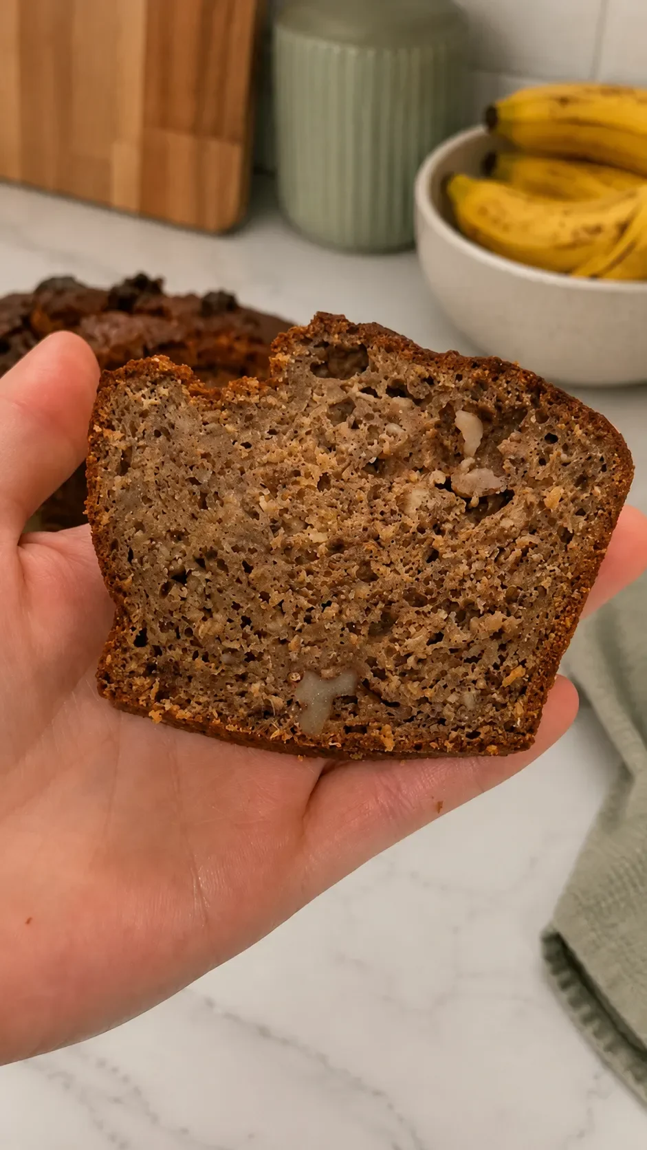 Close-up of soft homemade banana bread with wholemeal flour, seeds and nuts, served untoasted.