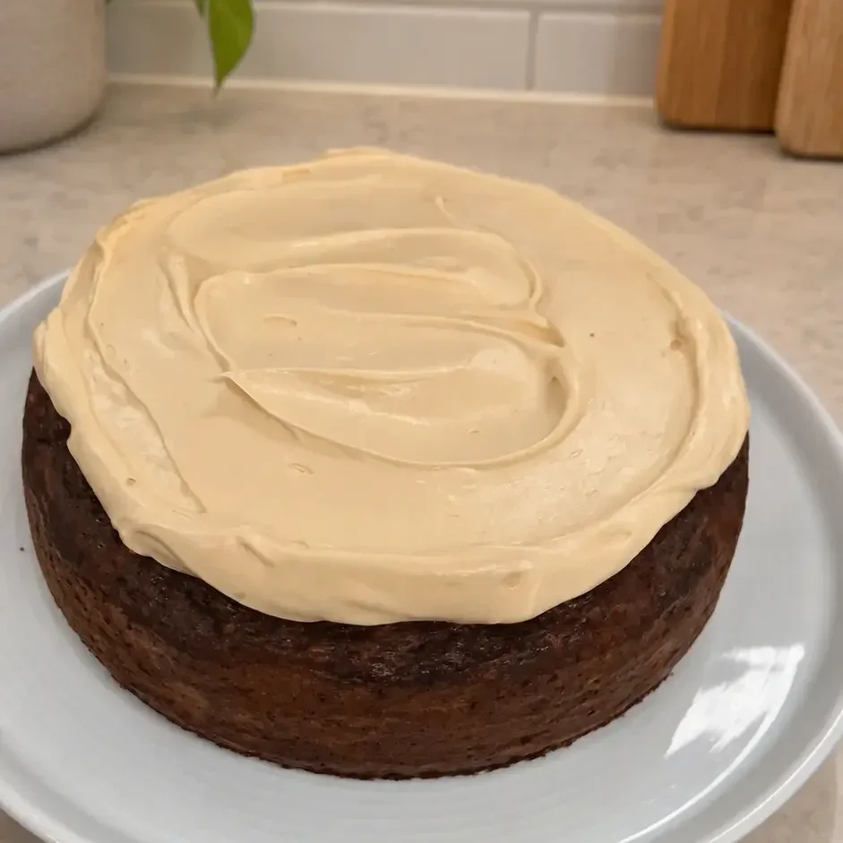 Homemade healthy carrot cake made with almond meal, grated carrots and olive oil, topped with creamy mascarpone frosting.