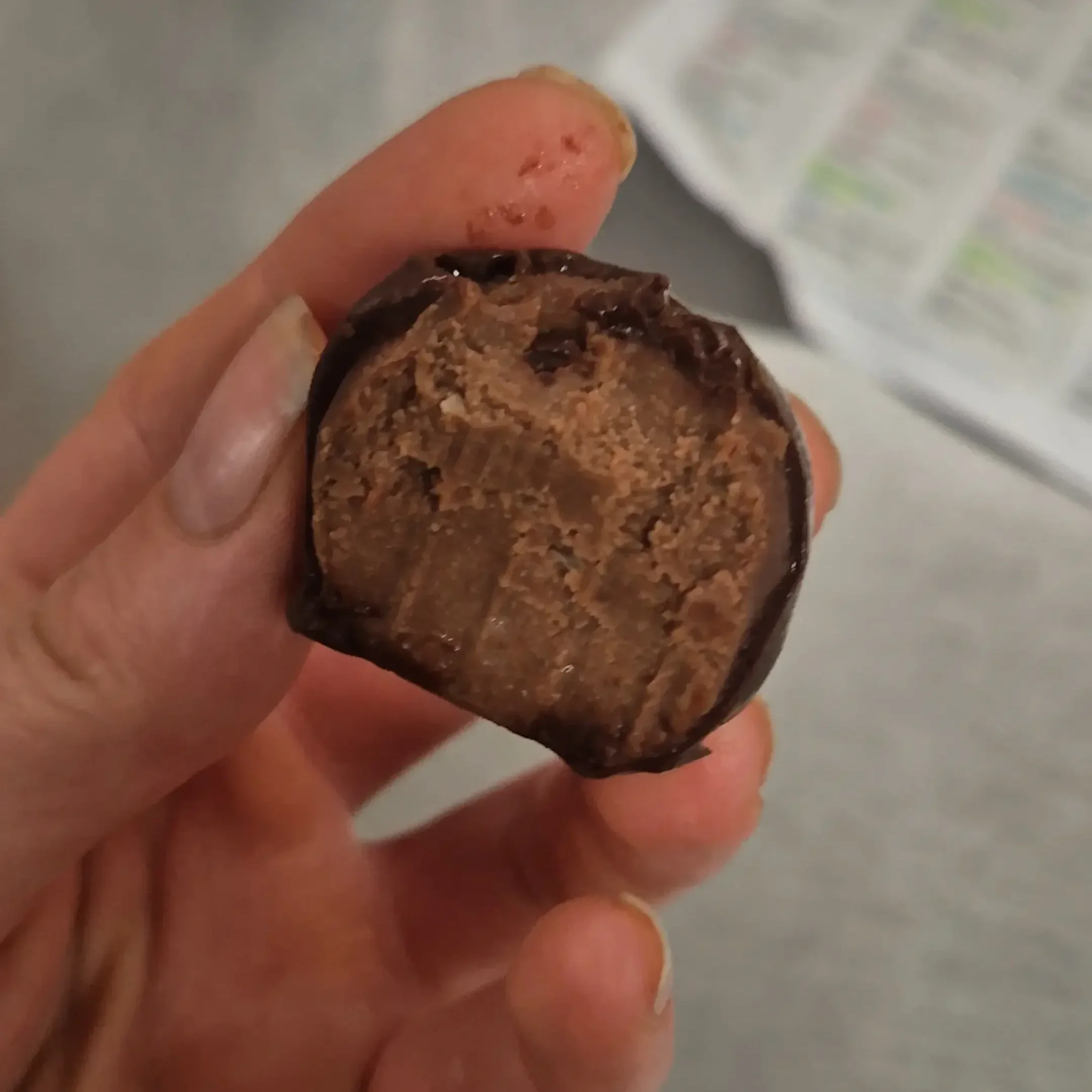 A bitten easy chocolate chickpea truffle showing the smooth, fudgy centre made with chickpeas, tahini, and dark chocolate.