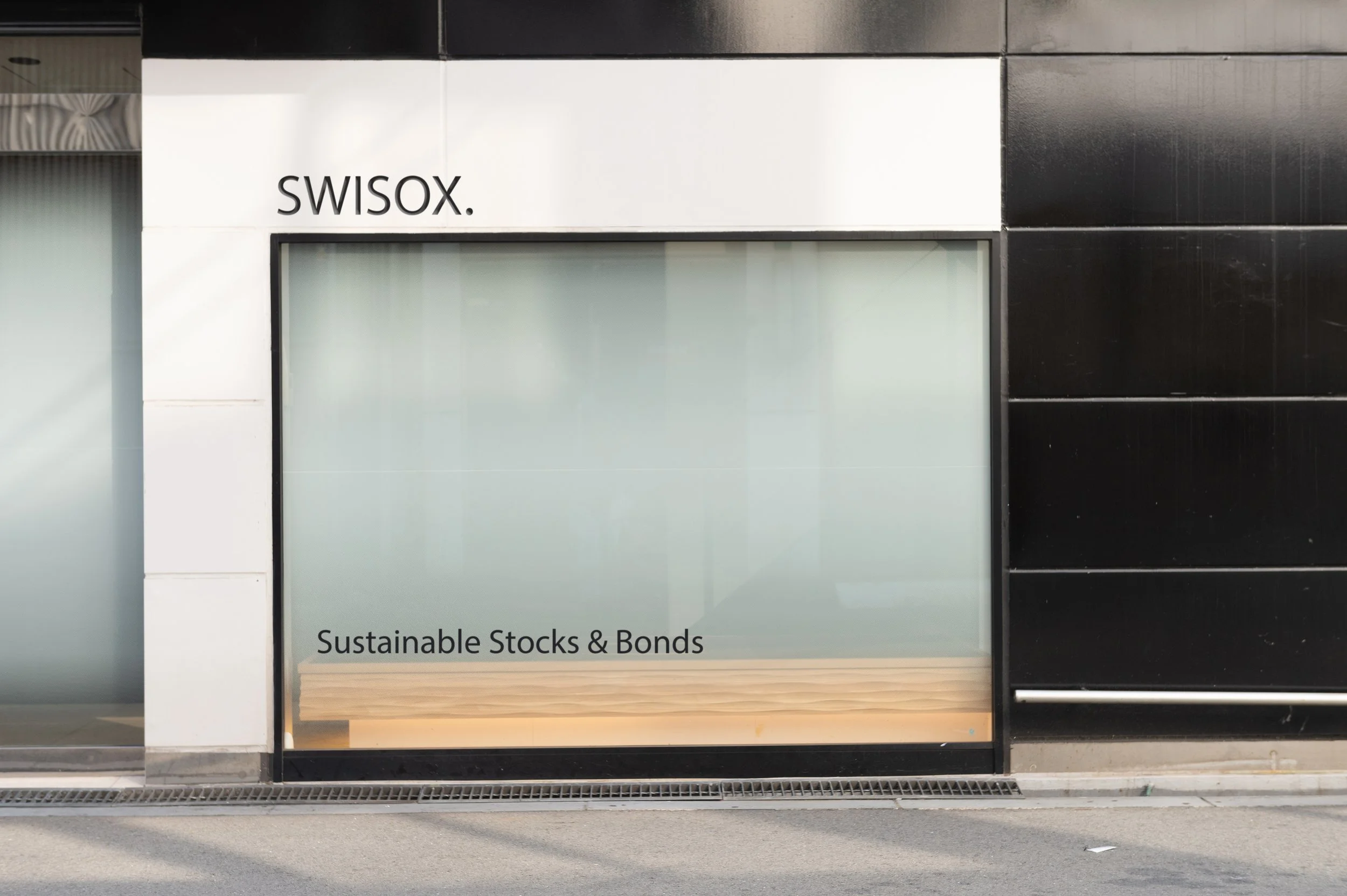 Storefront with SWISOX branding and text 'Sustainable Stocks & Bonds' on the window.