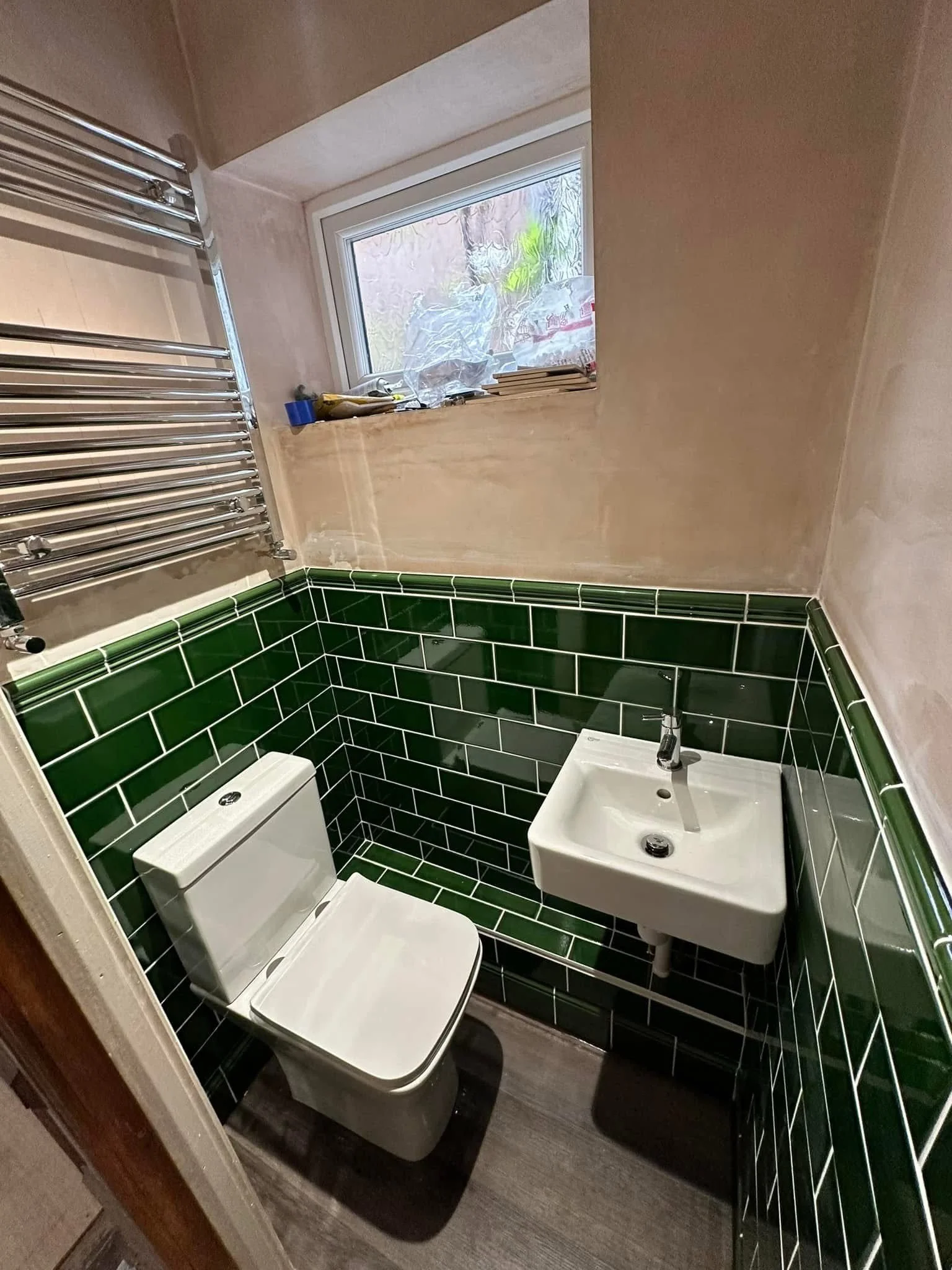 W/C with green metro tiles floating sink and toilet