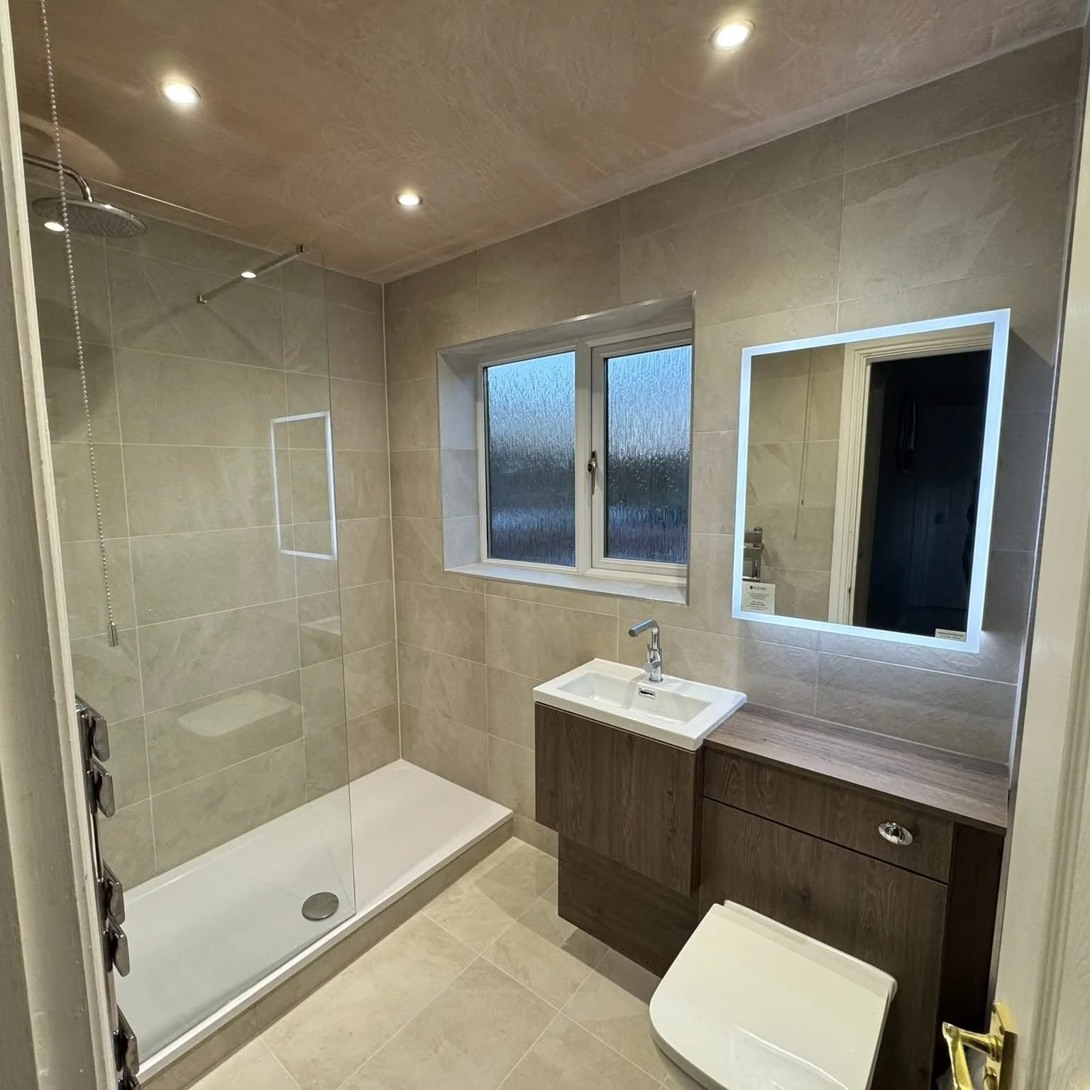 ivory tiles, dark wooden bathroom furniture walk in shower light up mirror Washington