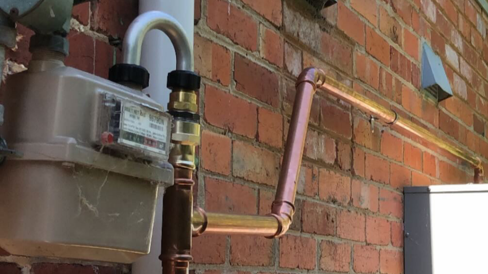 Melbros plumbers inspecting and servicing gas fittings in Melbourne, VIC