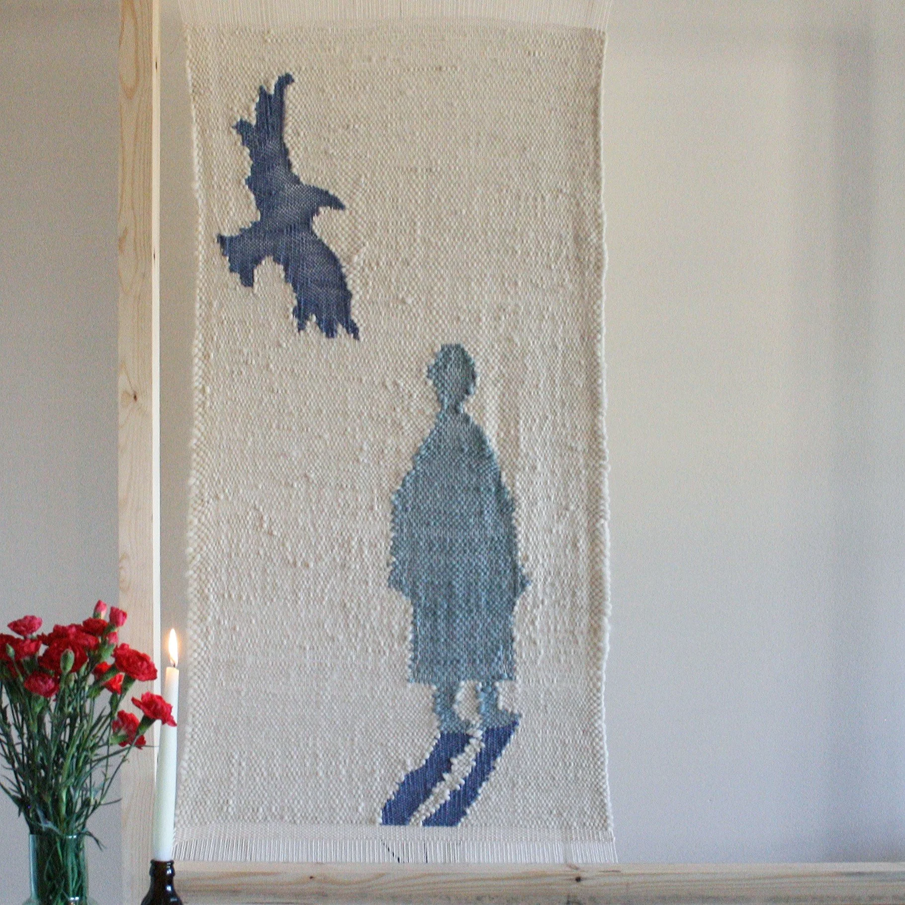 large hand woven piece on wooden frame 