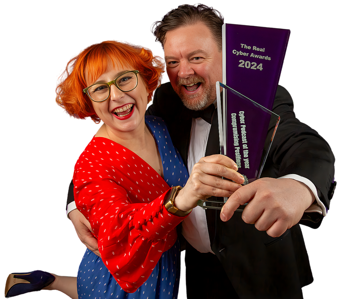 Two joyous people, a woman with red hair and glasses wearing a red dress with white polka dots and a man in a tuxedo, holding awards at the Cyber Awards 2024 ceremony.