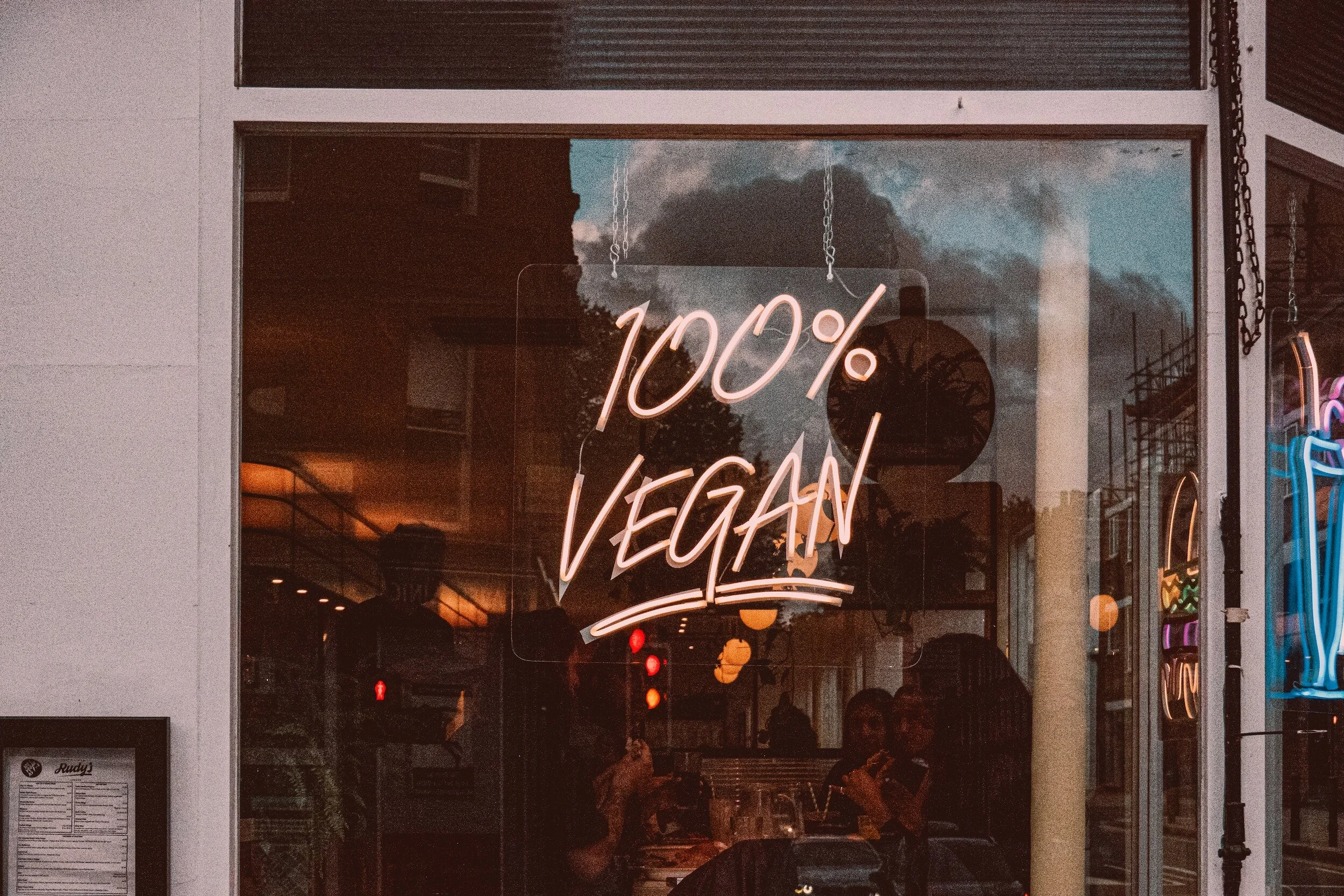 Neon sign outside a restaurant that says 100% vegan