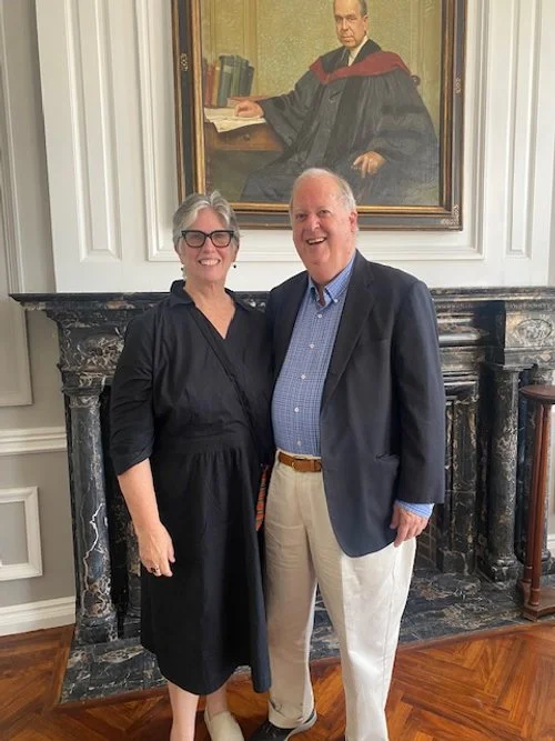 Ned and Peggy in front of portrait of Rev. Dr. J.