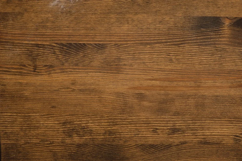 Close-up of a wooden surface with visible grain and texture.