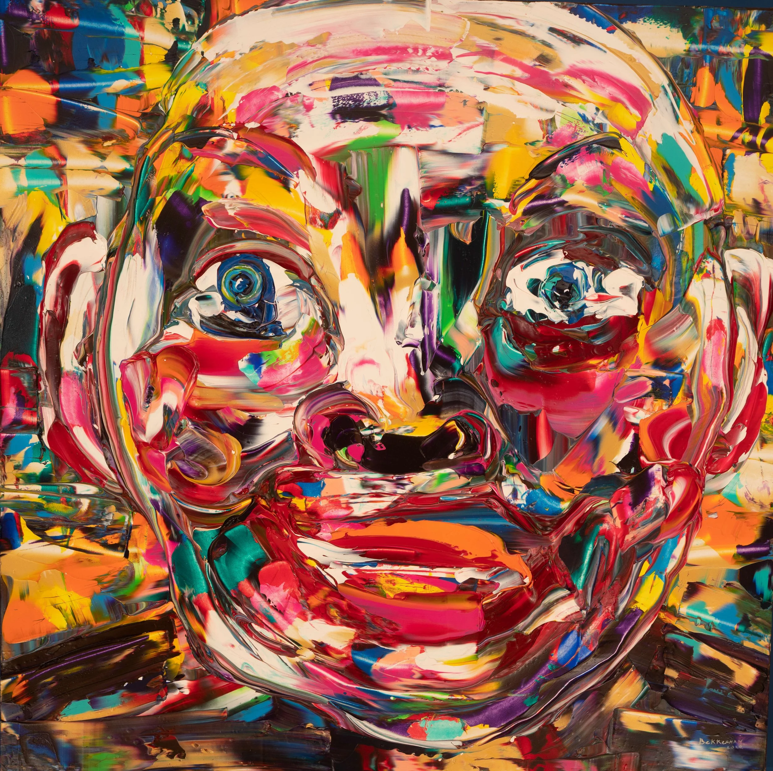Abstract portrait painting 'I Am Sure!' (2020) rendered in thick, expressive strokes of vivid reds, yellows, blues, greens, and purples, depicting a large, wide-eyed, smiling face that emerges from a dynamic swirl of color and texture.